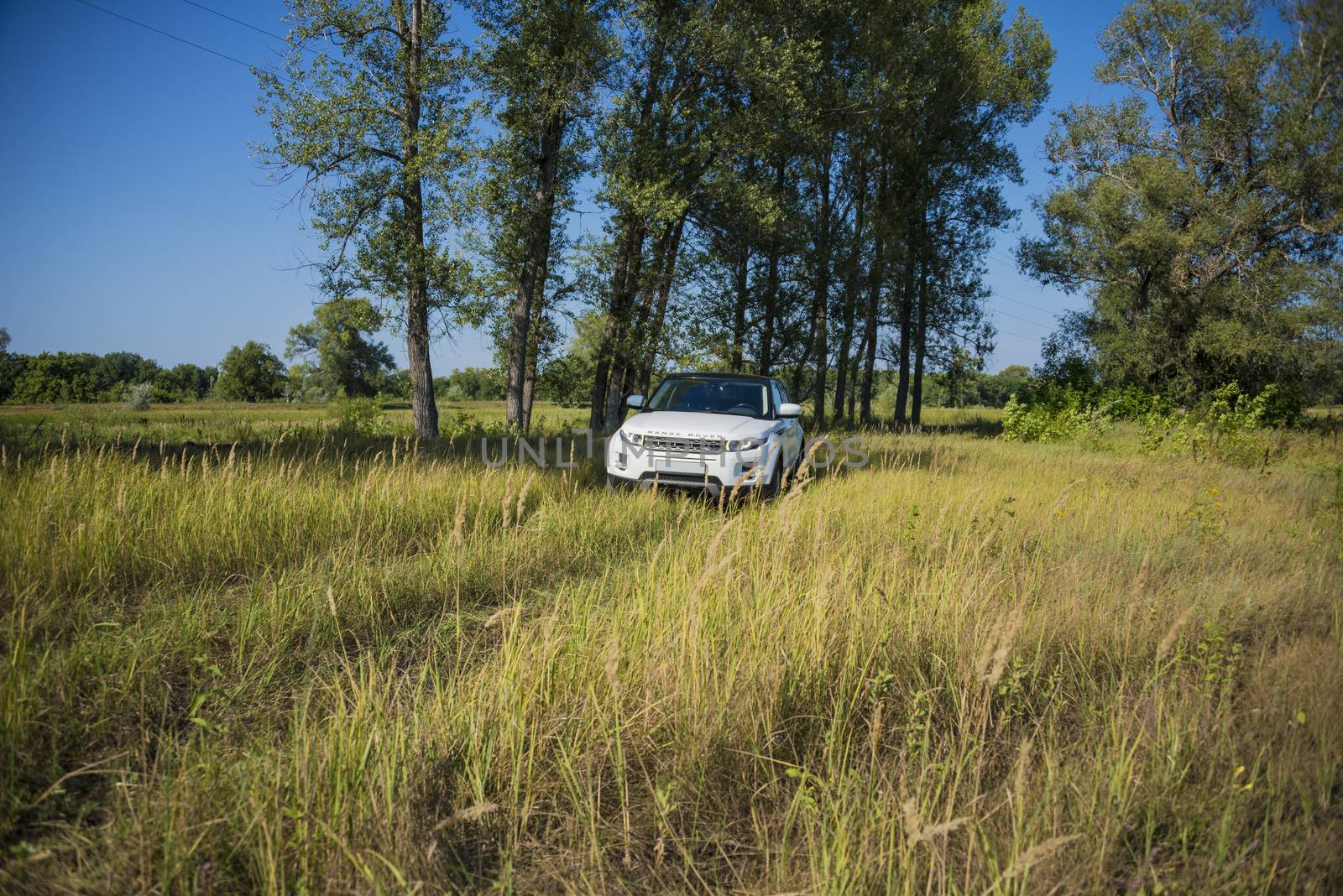Car Land Rover Range Rover in summer Sunny weather in the summer landscape of the Samara region, Russia. August 21, 2018.