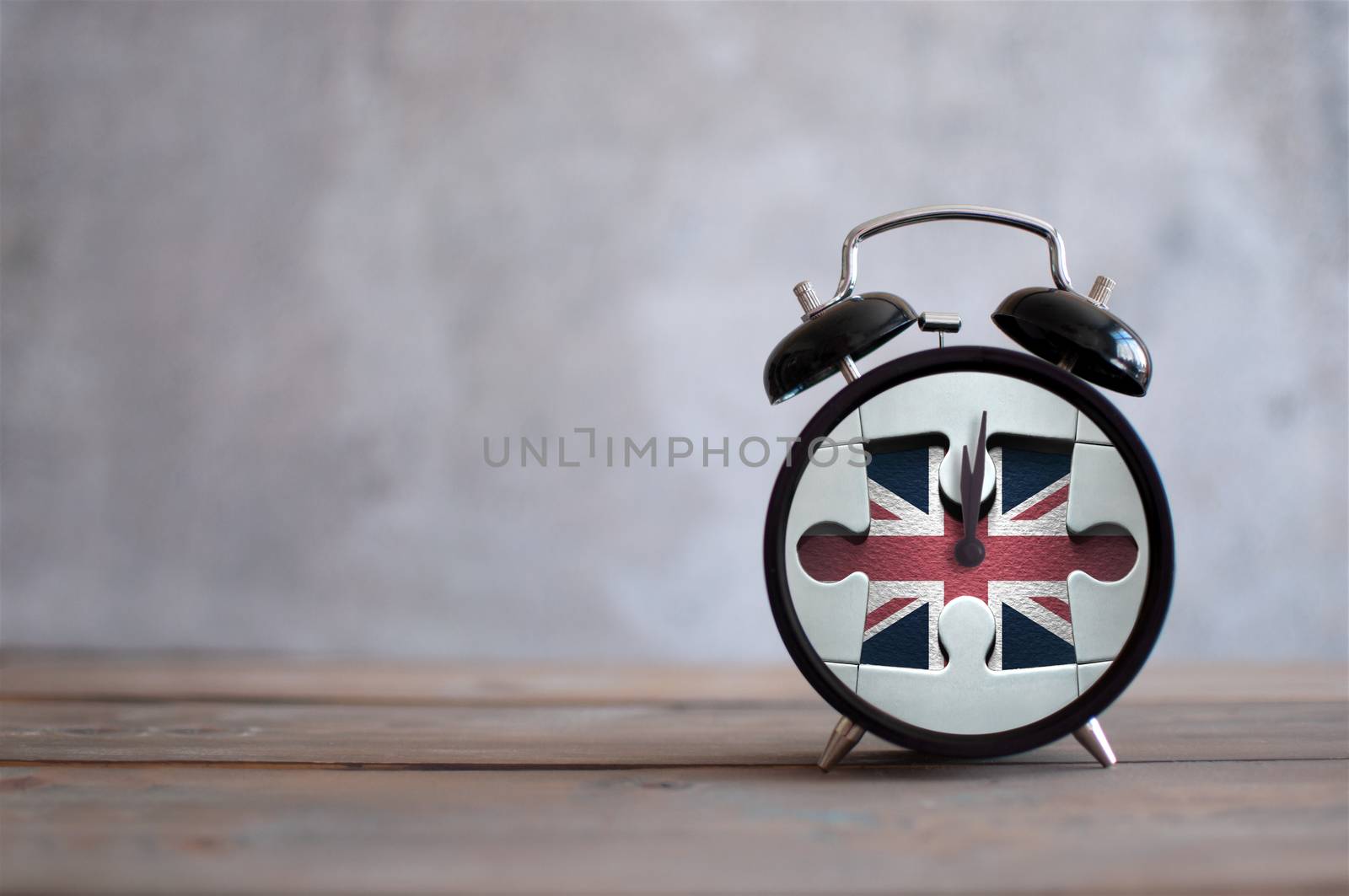 Clock with missing piece from a jigsaw piece british flag