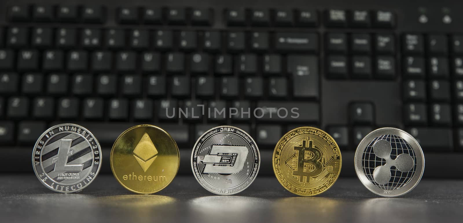 different virtual coins with keyboard background by compuinfoto