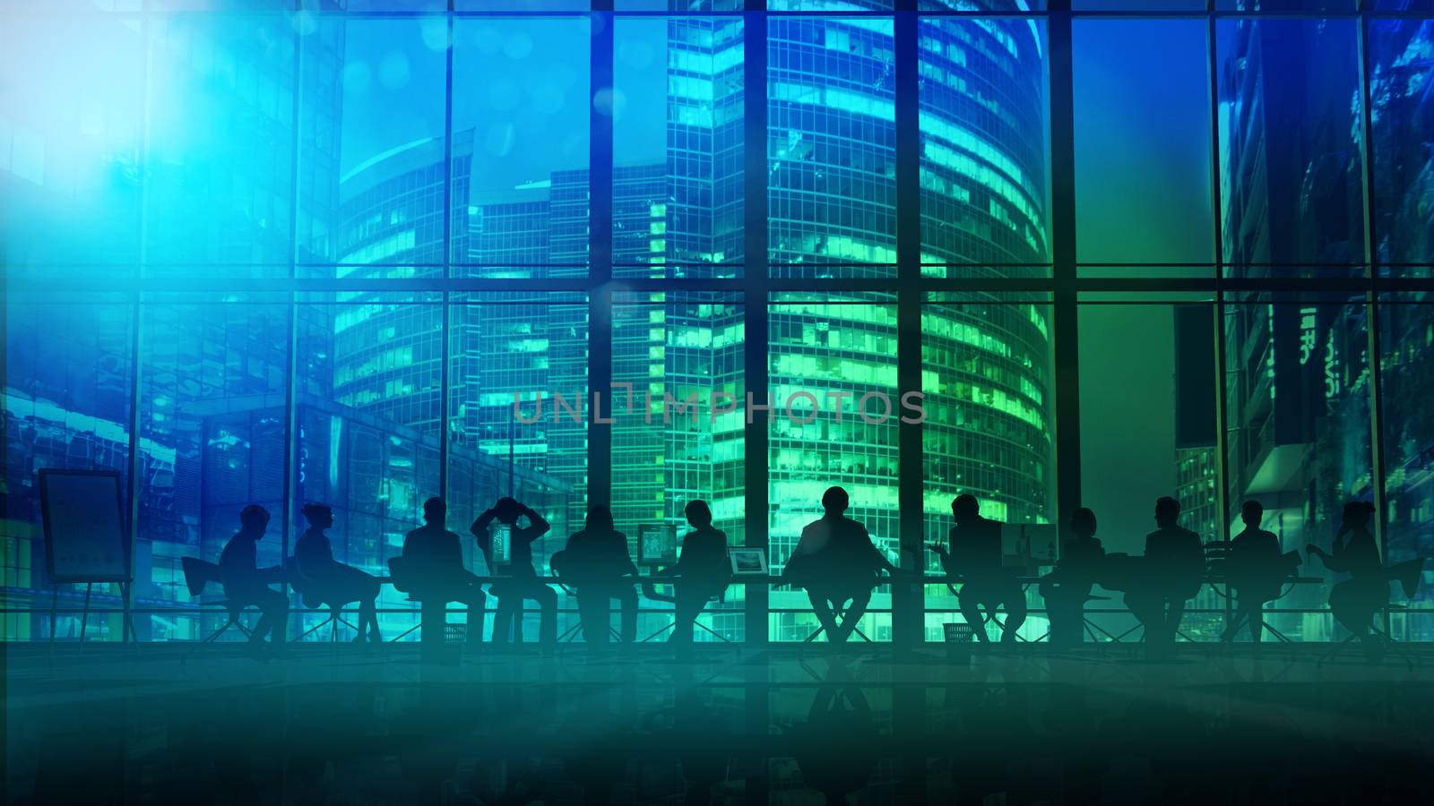 Silhouettes of employees led by their leader in a large office in front of a panoramic window.