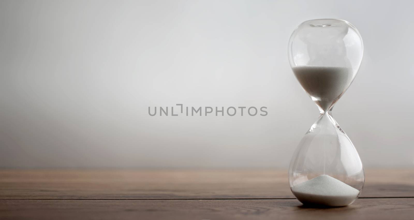 Sand flowing through hourglass 