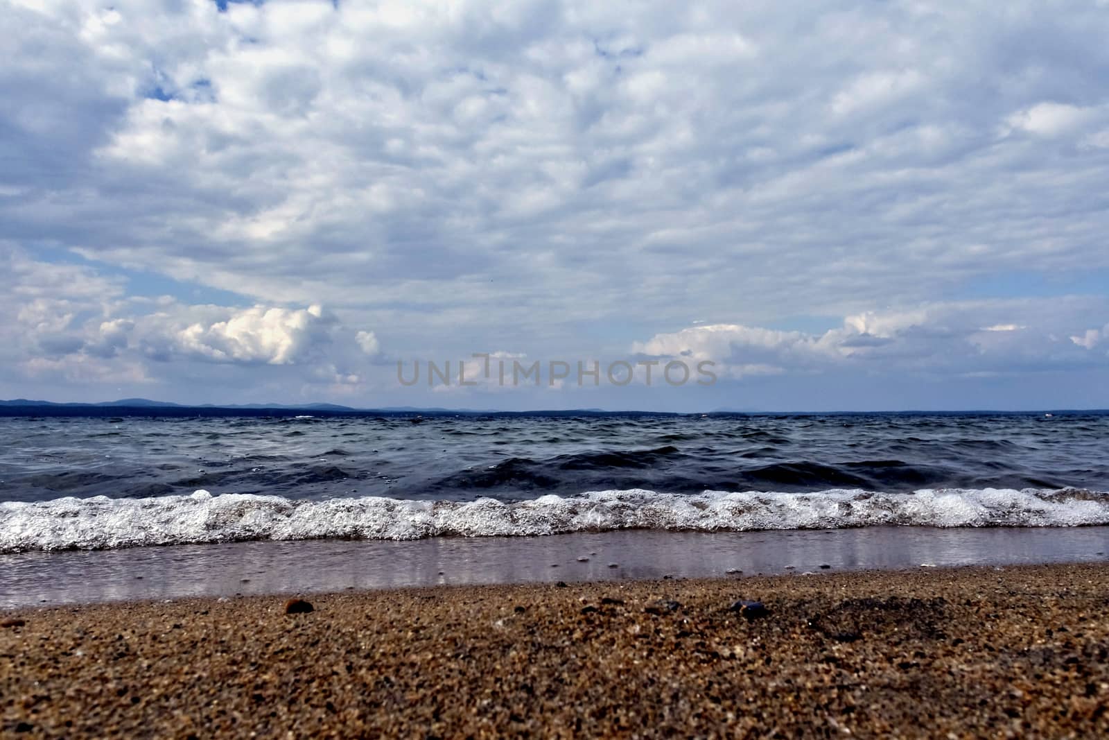 view of the lake with cumulonimbus clouds above it in windy weather, low point shooting