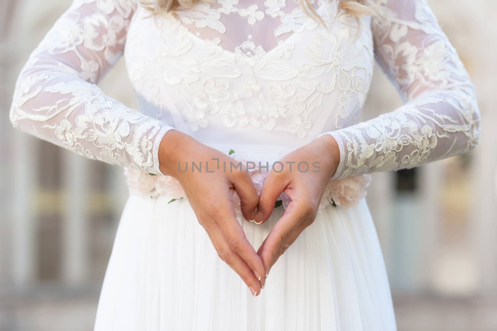 Bride making heart sign. Love concept