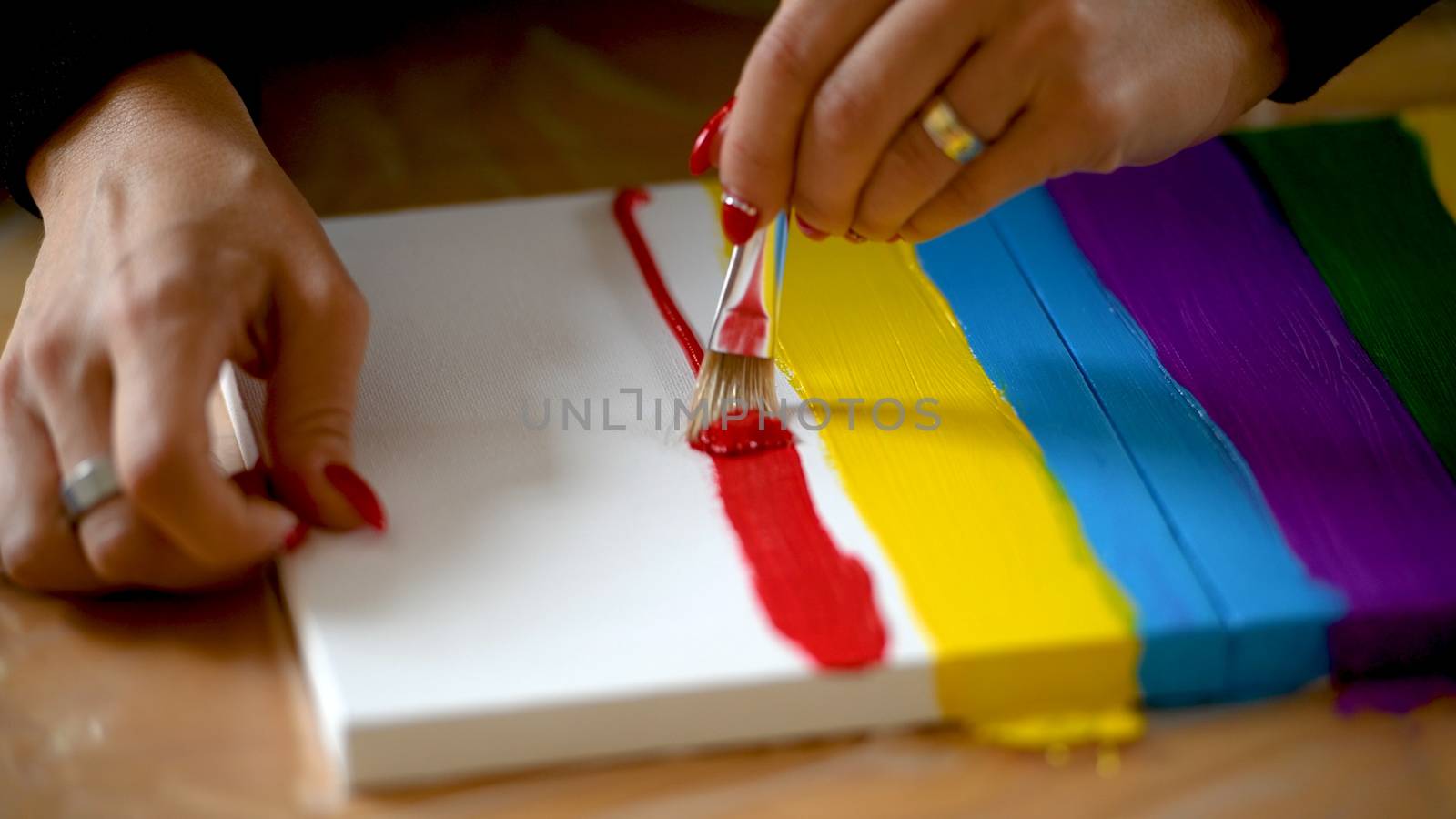 Painting rainbow on canvas, gay pride, transsexuality concept, sexual diversity