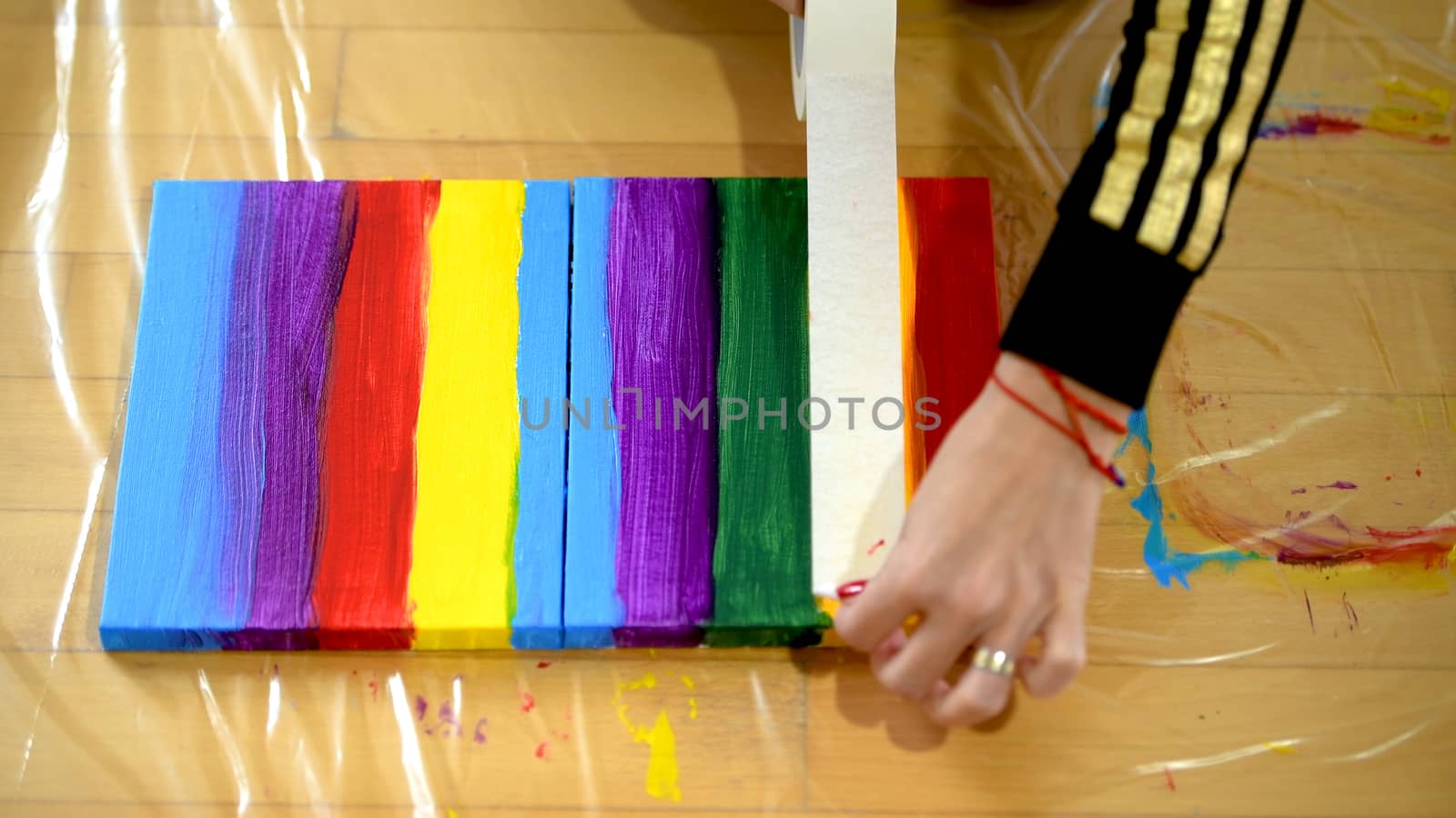 Female artist painting a rainbow with acrylic colors on canvas, hoe made art, DIY tutorial, colorful
