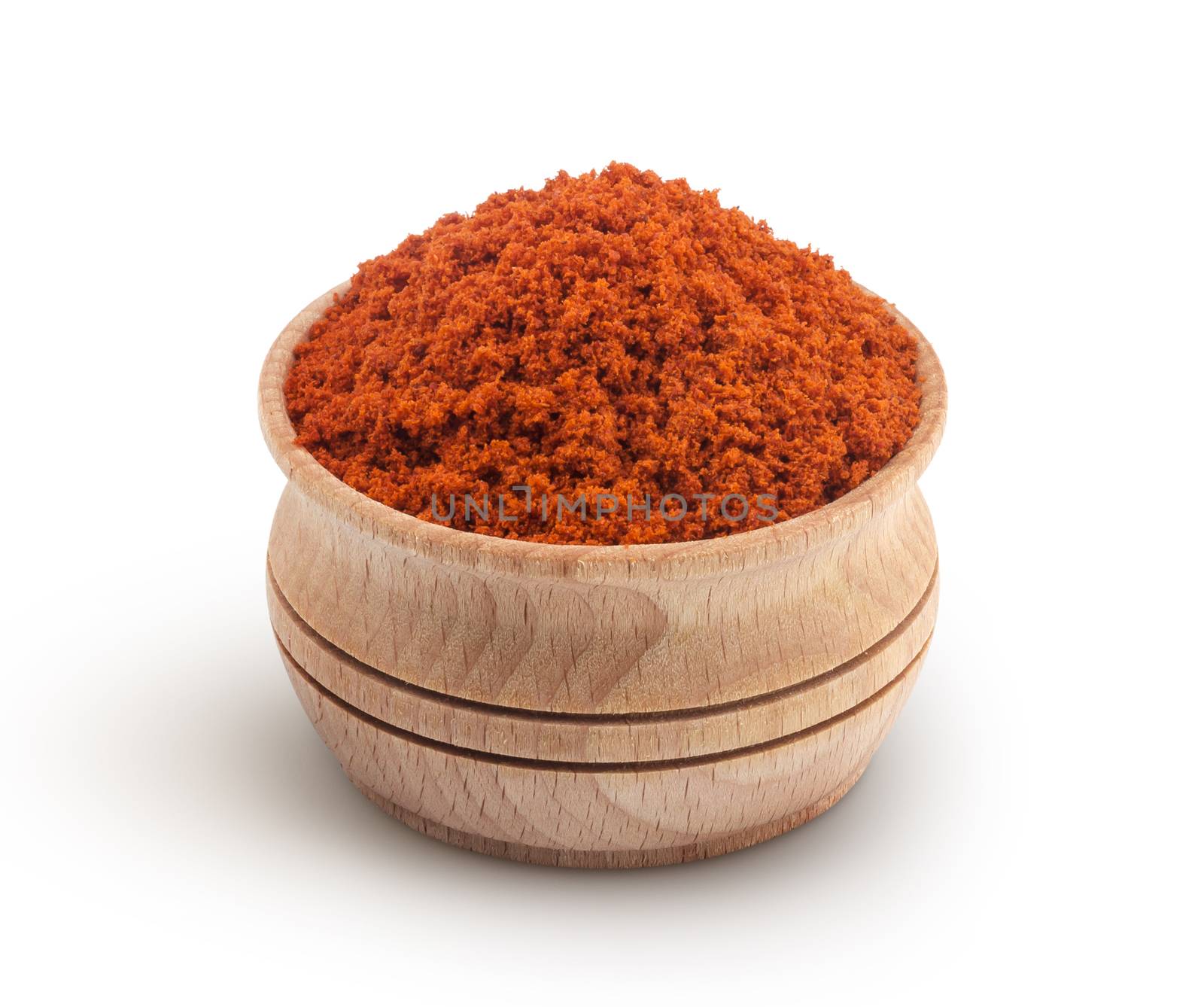 Pile of red paprika powder in wooden bowl isolated on white background
