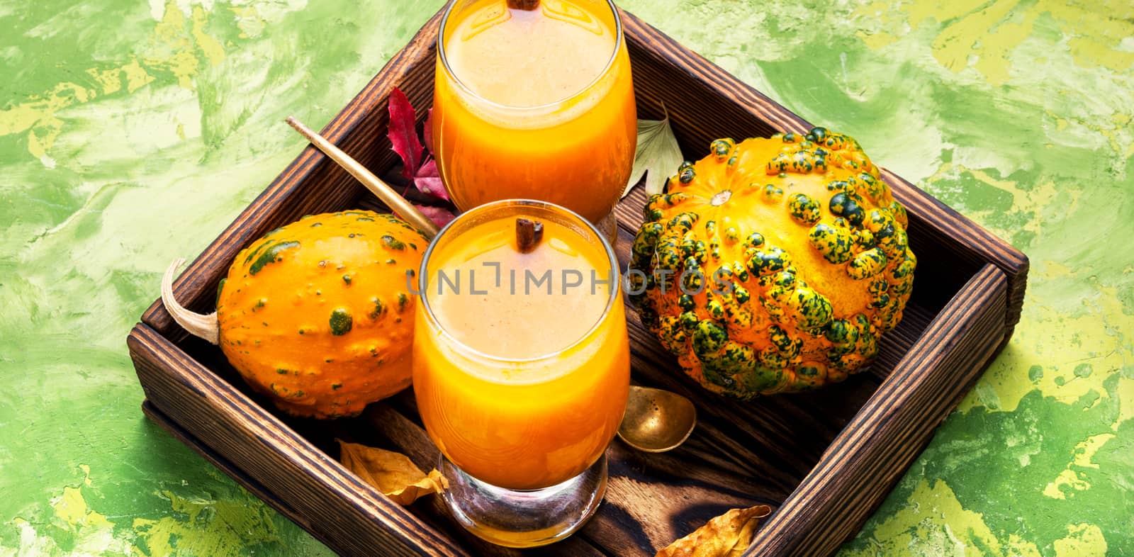 Pumpkin smoothie in glass on vintage table.Autumn drink.