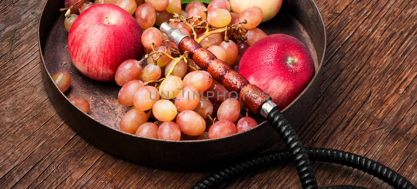 Turkish smoking hookah with taste of a fruit mixture of grapes and apples.Shisha concept. Fruit taste of hookah.