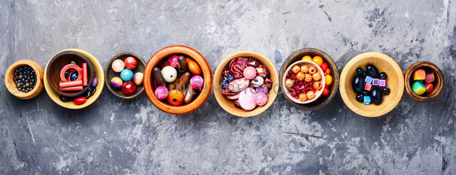 Colorful beads in wooden bowls by LMykola