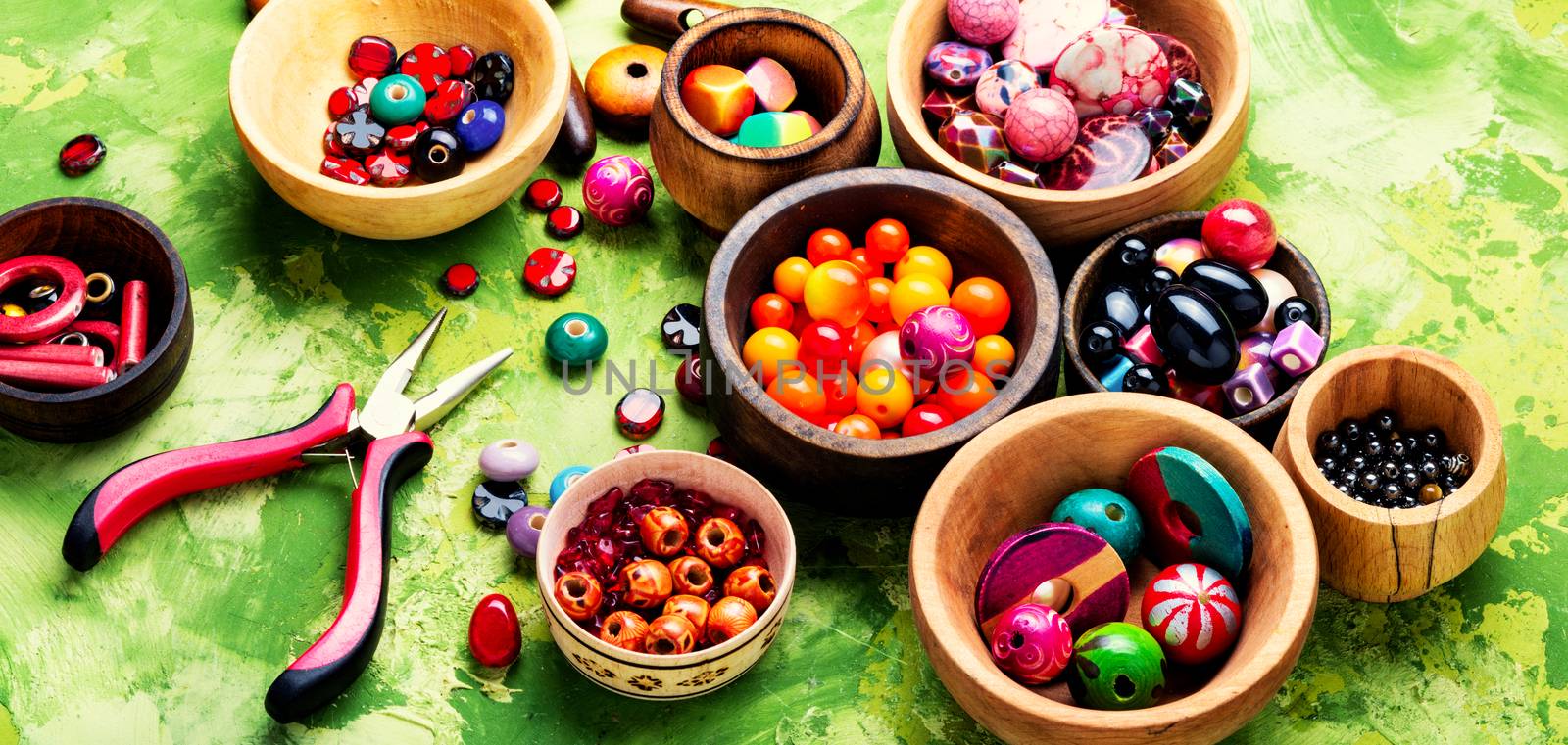 Colorful beads in wooden bowls by LMykola
