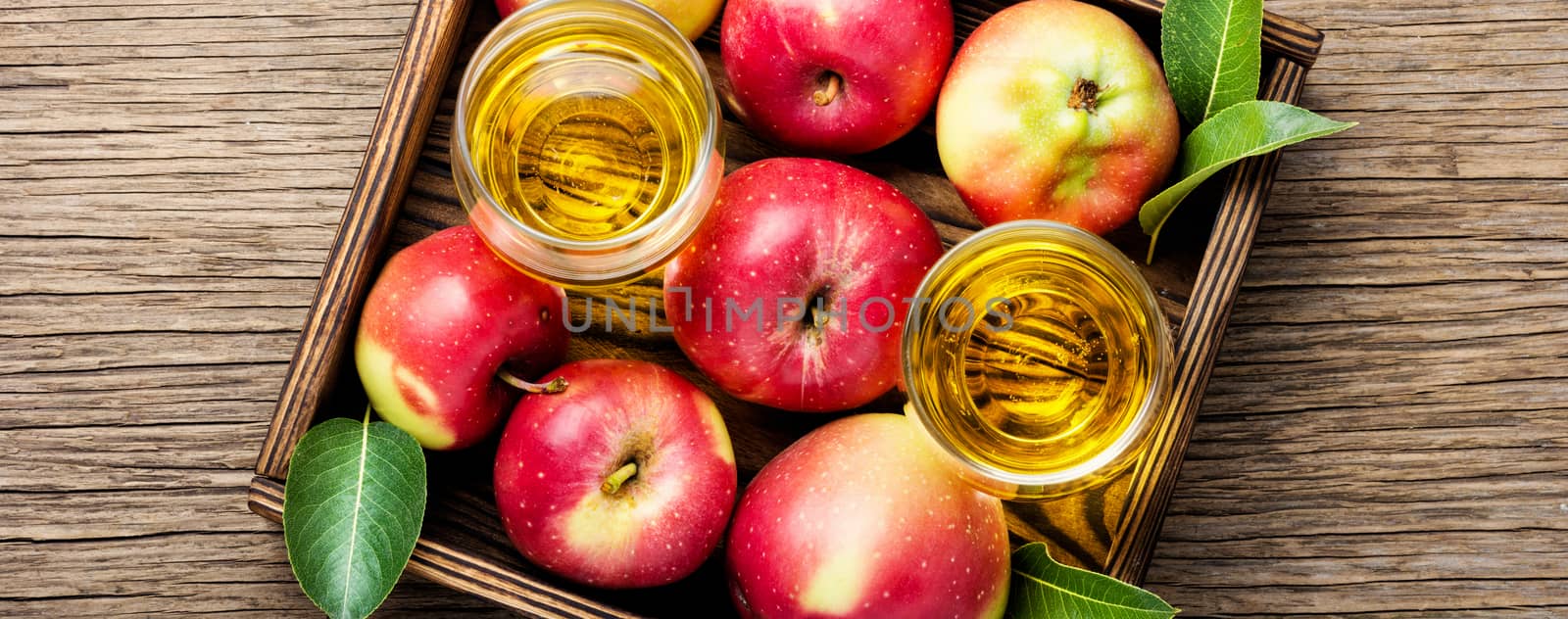 Apple cider with fresh apples on rustic background.Refreshing apple cider