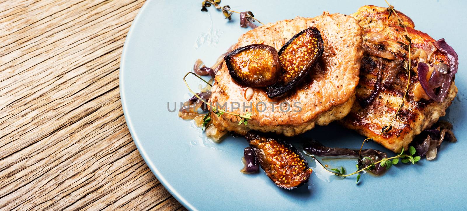 Grilled meat steak with figs on plate.Steak with figs sauce