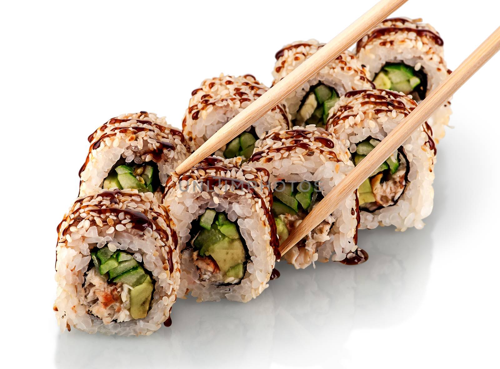 Few pieces of sushi roll california. Two rows of sushi sprinkled with unagi sauce and chopsticks. Reflection. Isolated on white background.