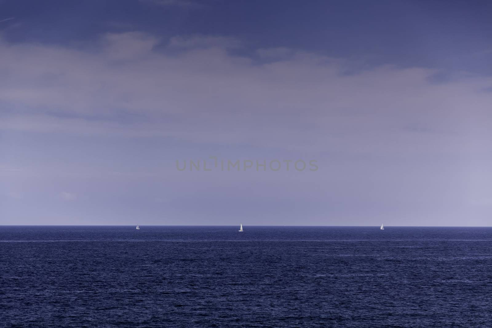 Boats in the distance, detail of boats on the high seas