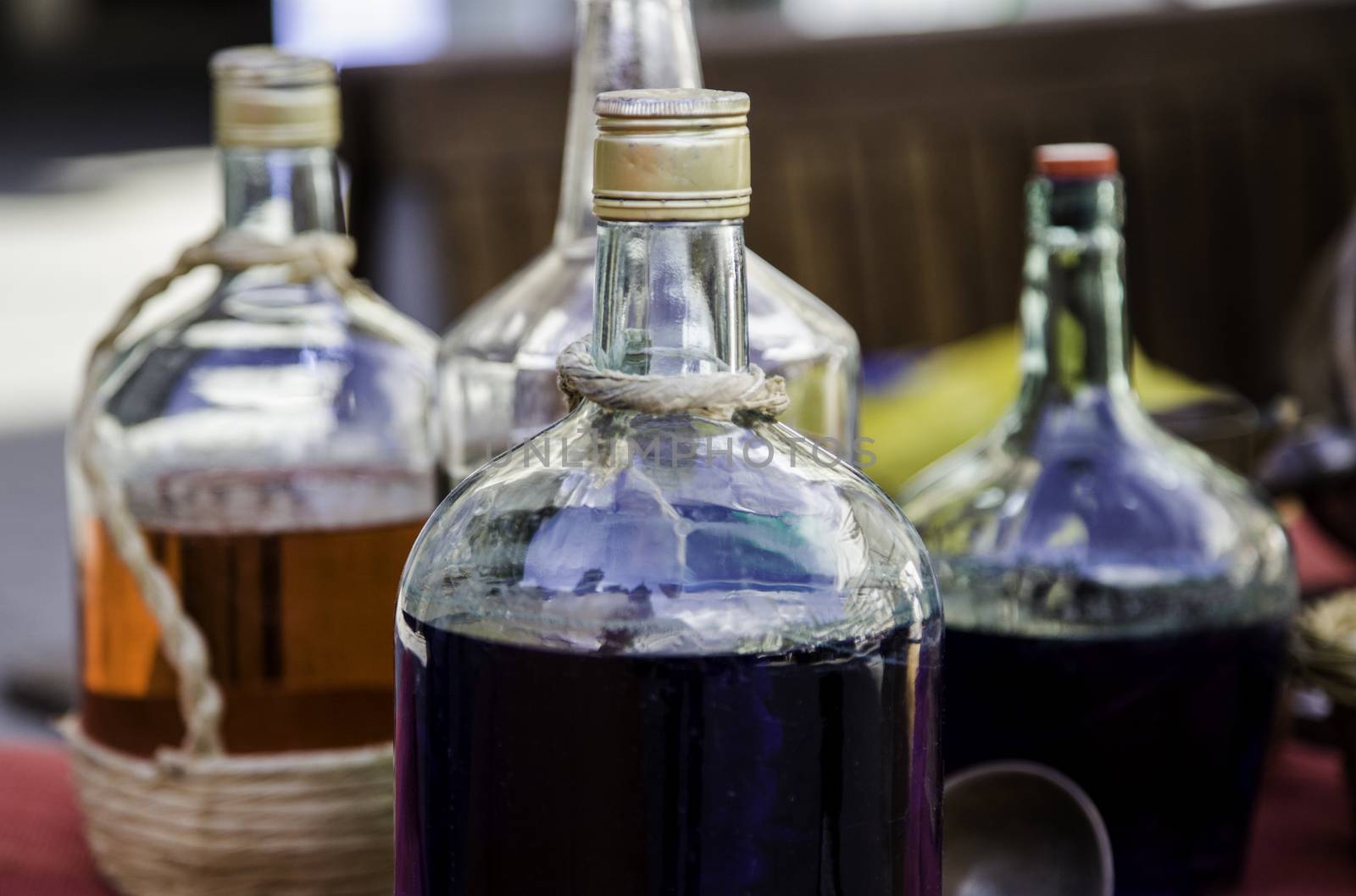 Bottles with colored liquid, detail of colors and glass, containers