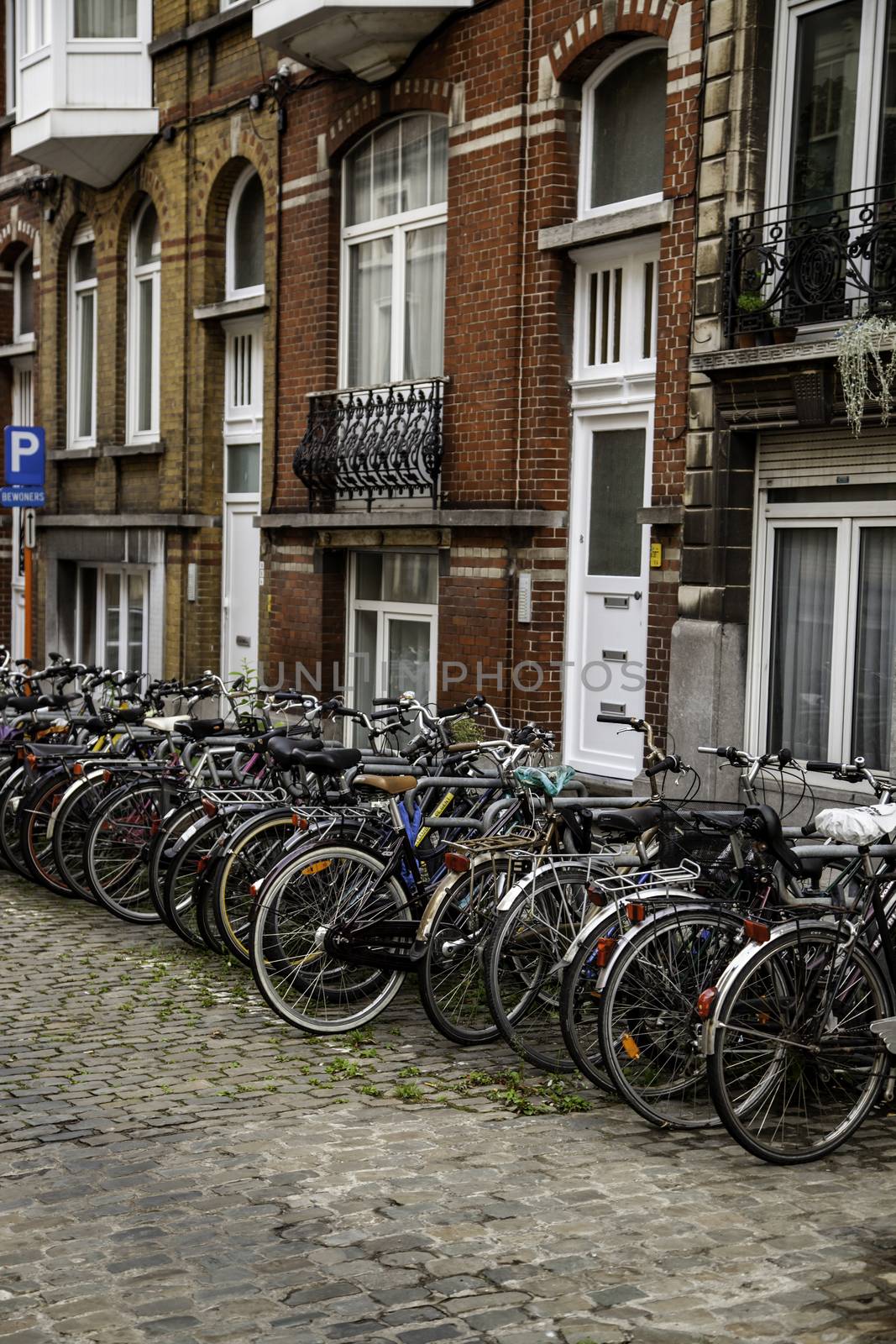 Typical bicycles parked in Holland, transport detail in the city, tourism in europe