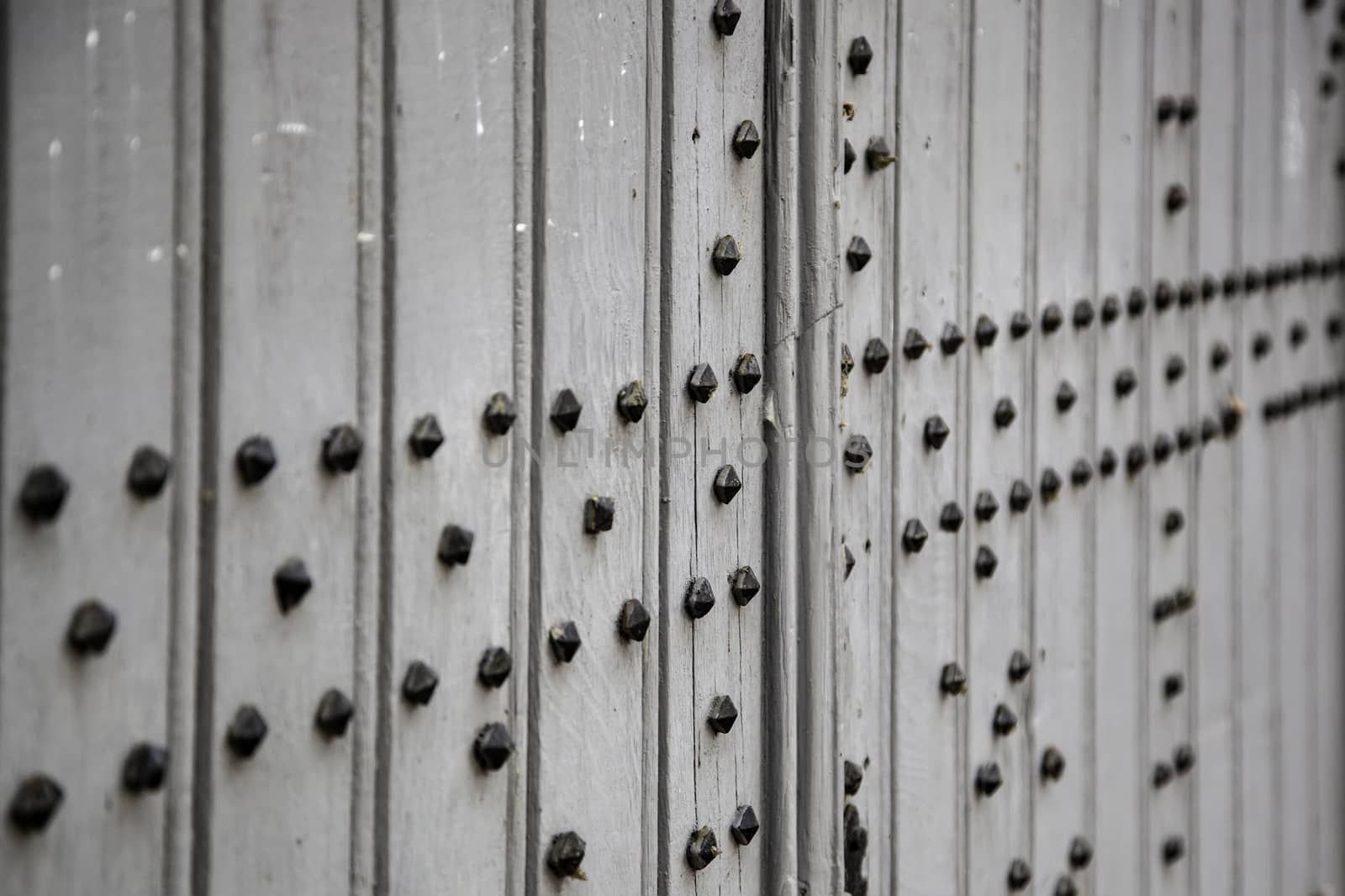 Old wooden door with metal, medieval door detail, decoration and security