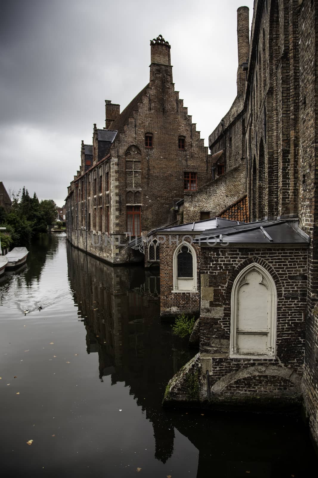 Medieval channels of Bruges, detail of tourism in a city of Belgium