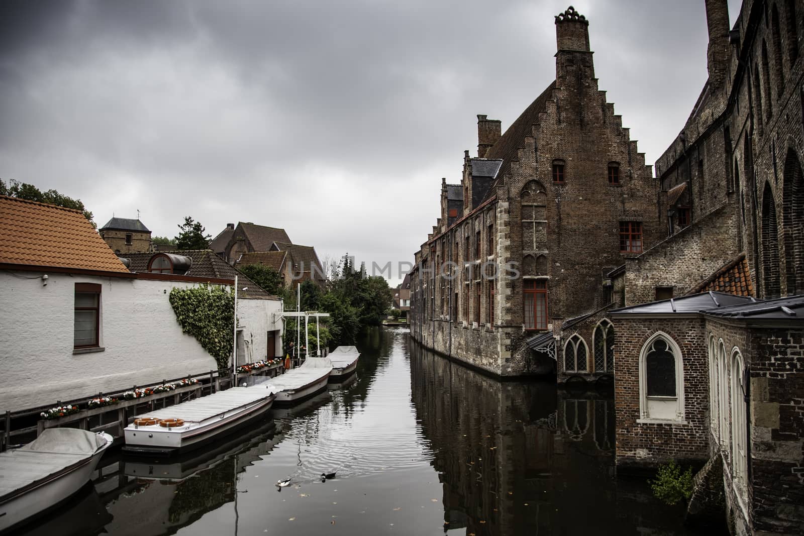 Medieval channels of Bruges, detail of tourism in a city of Belgium