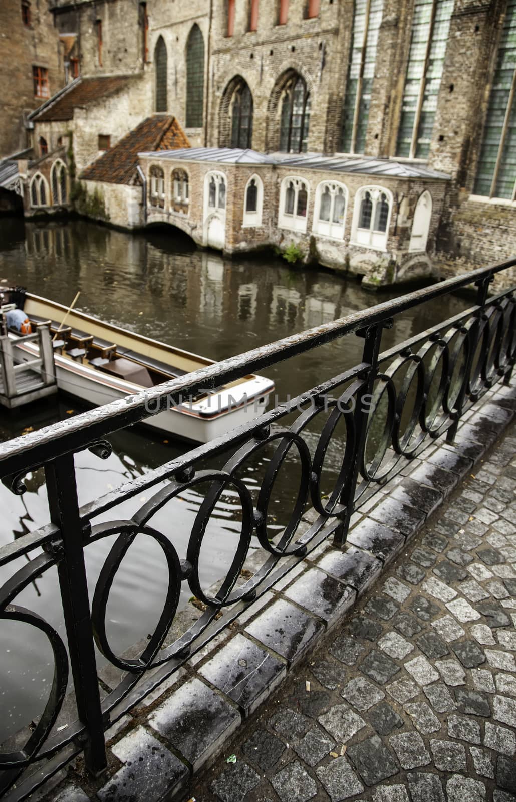 Medieval channels of Bruges, detail of tourism in a city of Belgium