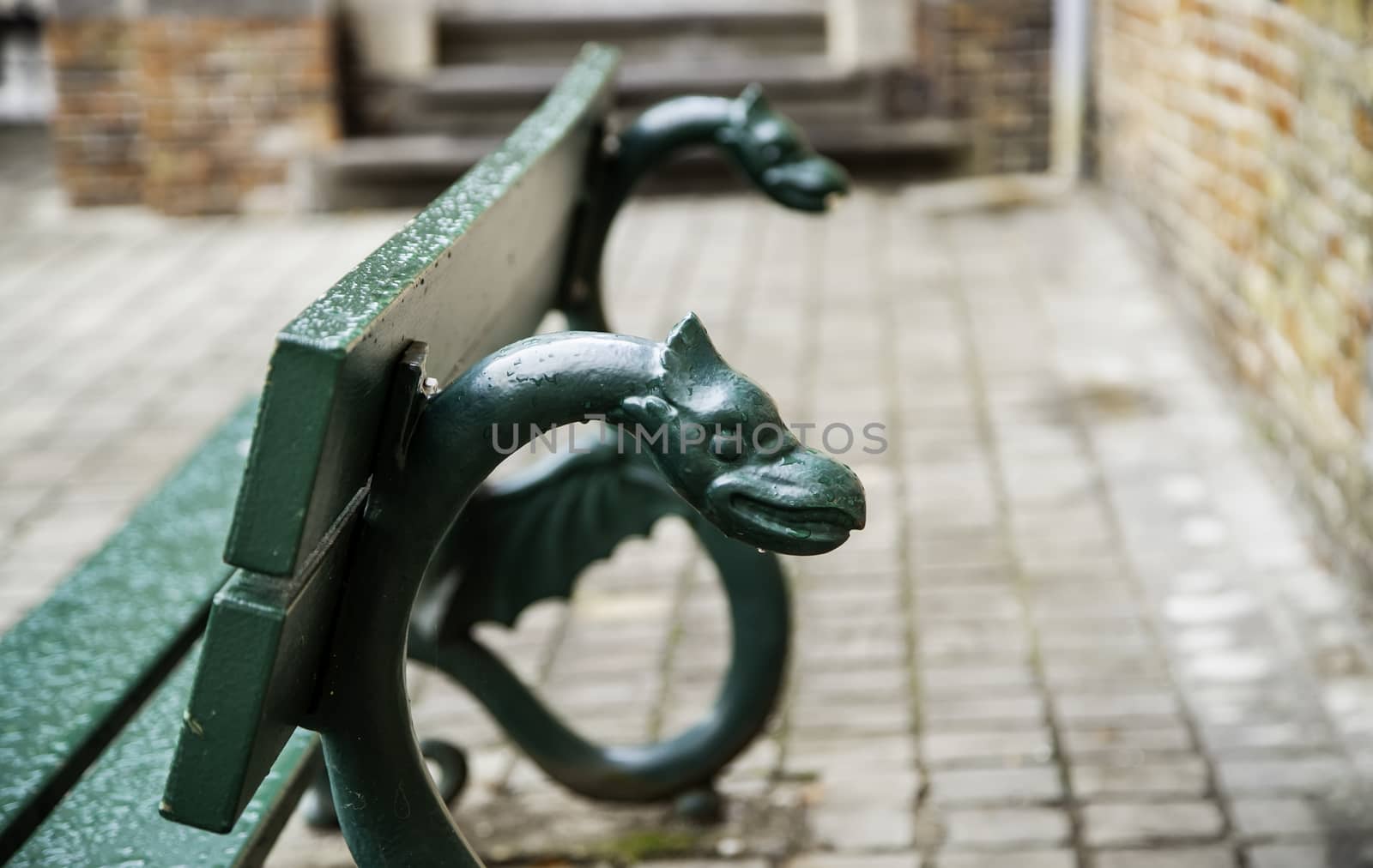Old bench to sit, bench decorated with mythological animals
