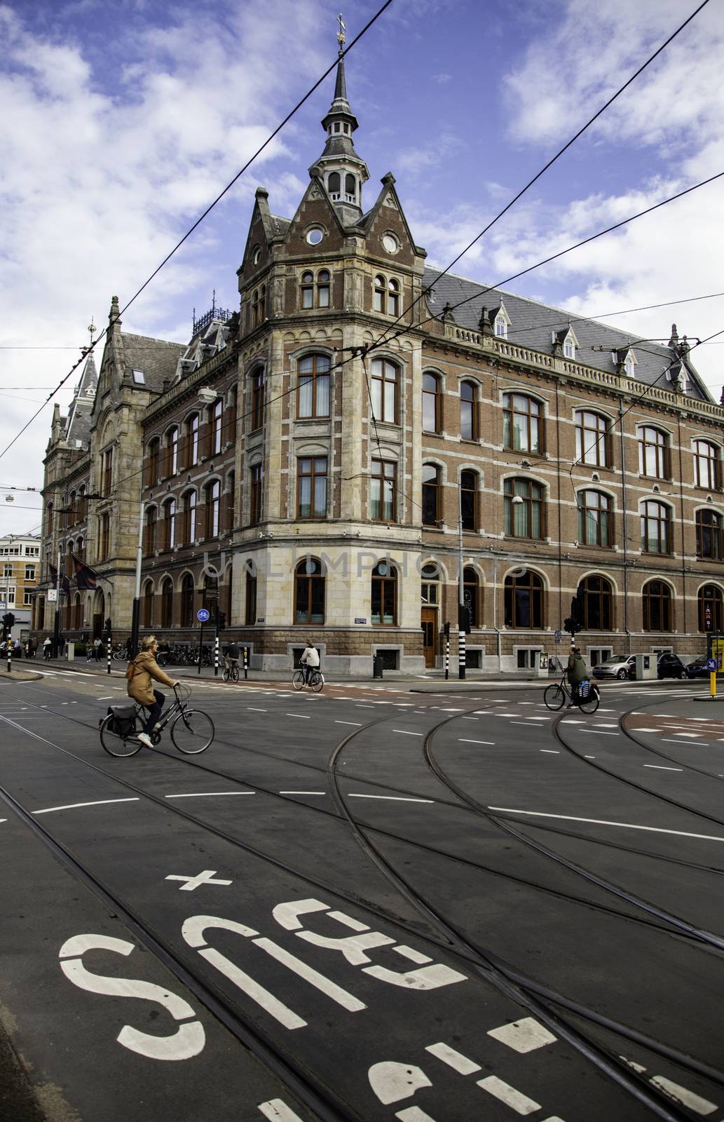 Bicycles in Amsterdam, people cycling, tourism in Europe