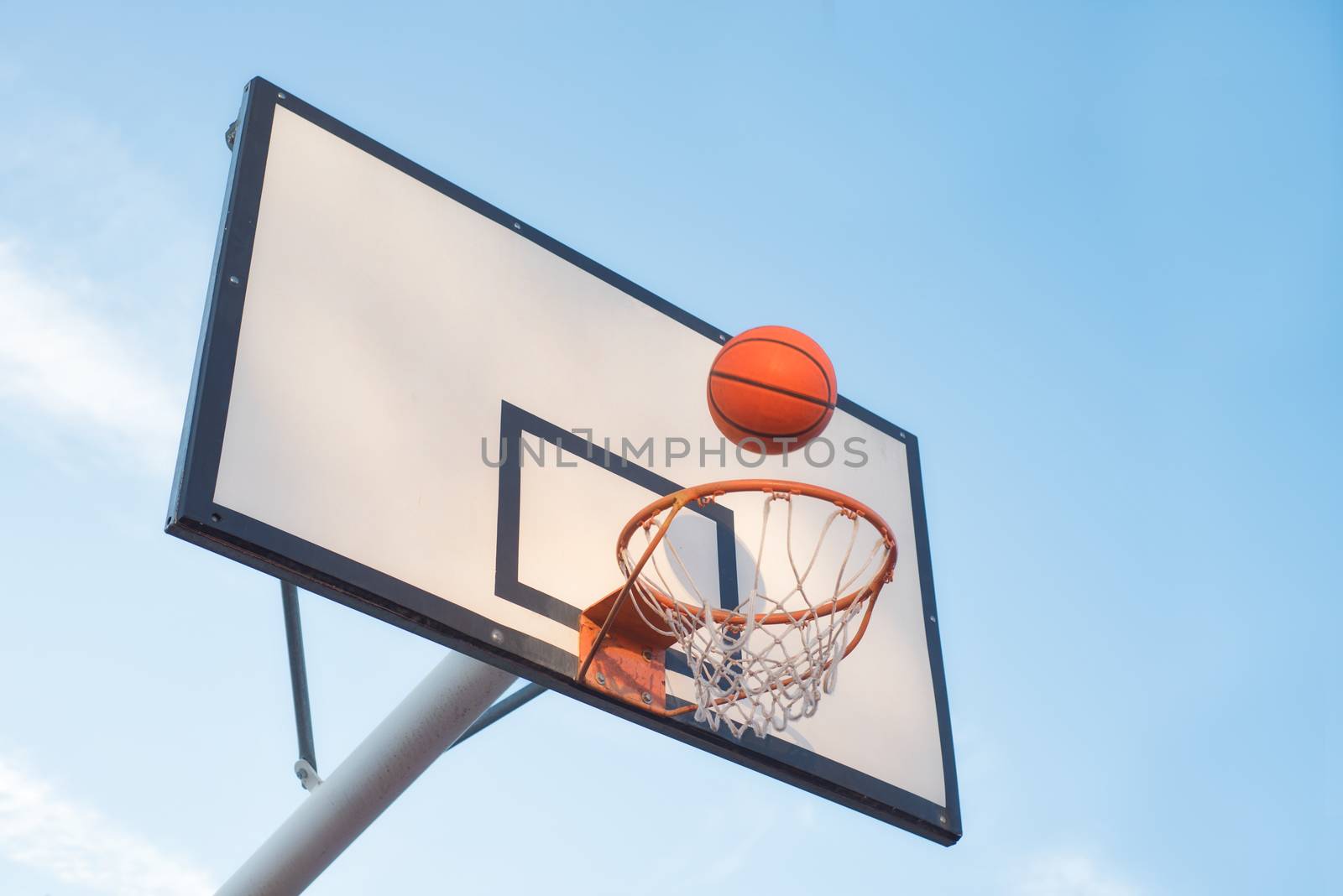 Basketball court goal with blue sky background by HERRAEZ