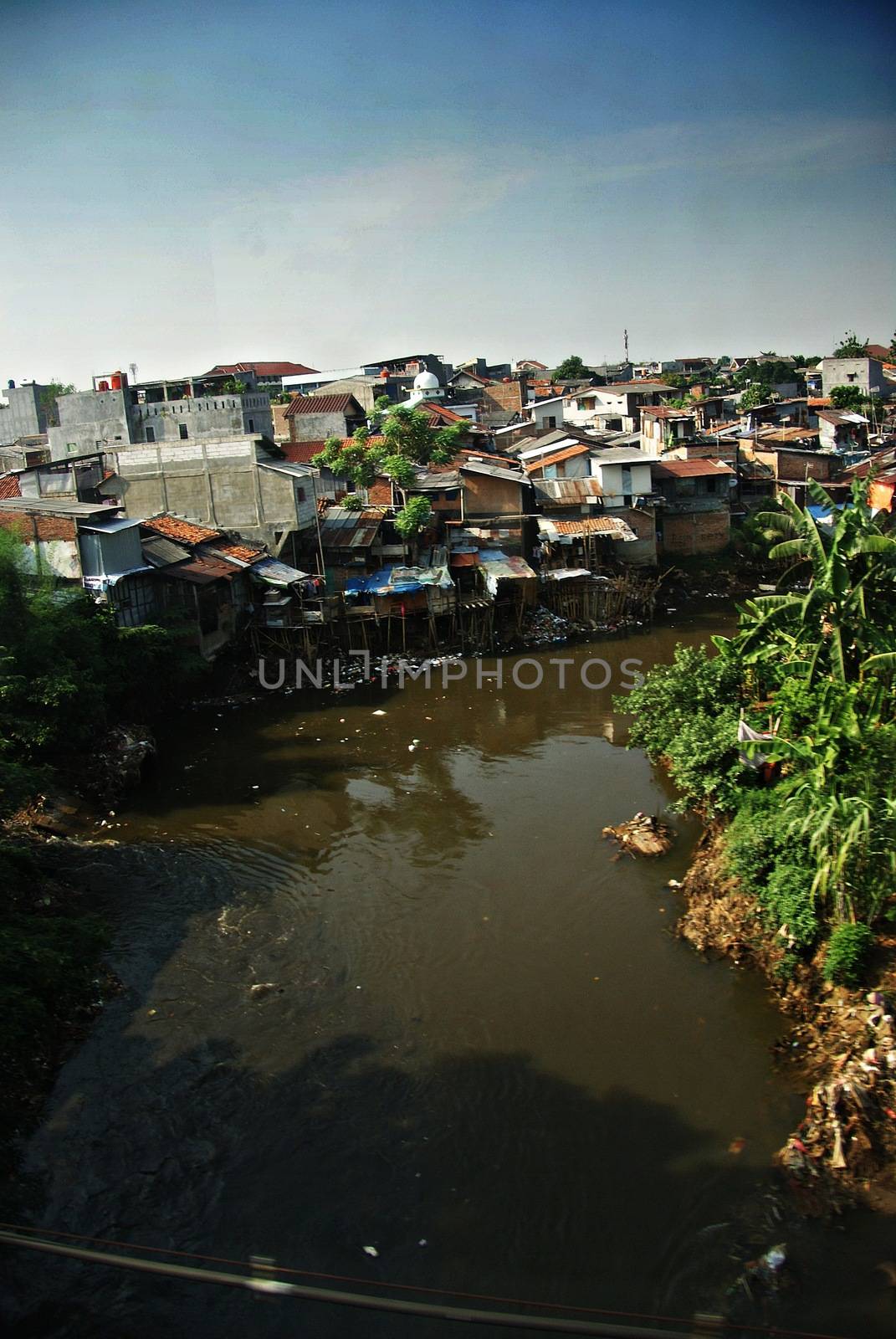 Jakarta slums area seen from a moving train