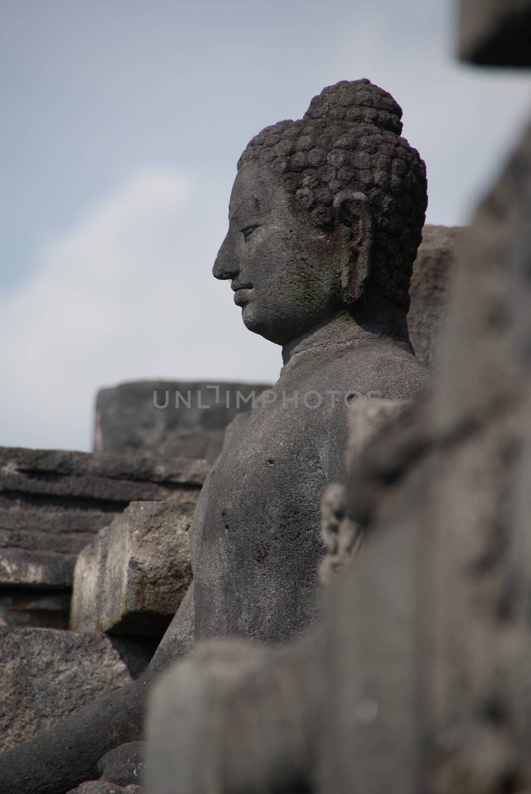 Image of sitting Buddha in Borobudur Temple, Jogjakarta, Indonesia by craigansibin