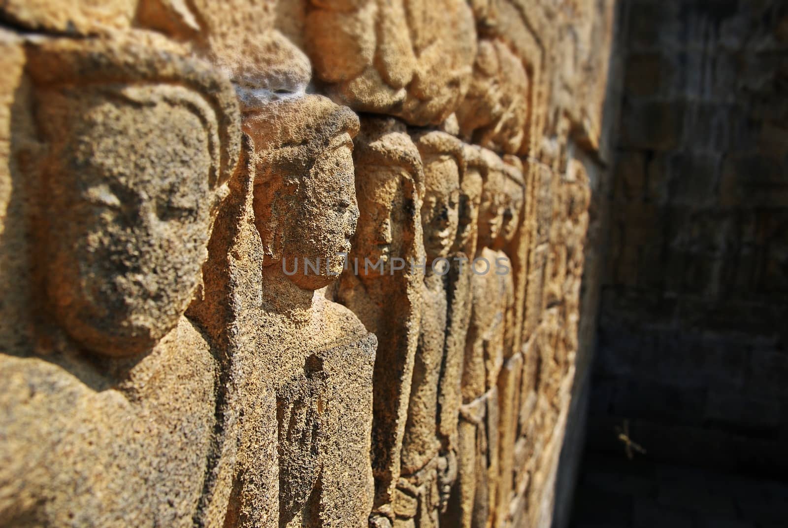 Relief or carvings on the wall of Borobudur Temple in Jogjakarta, Indonesia by craigansibin