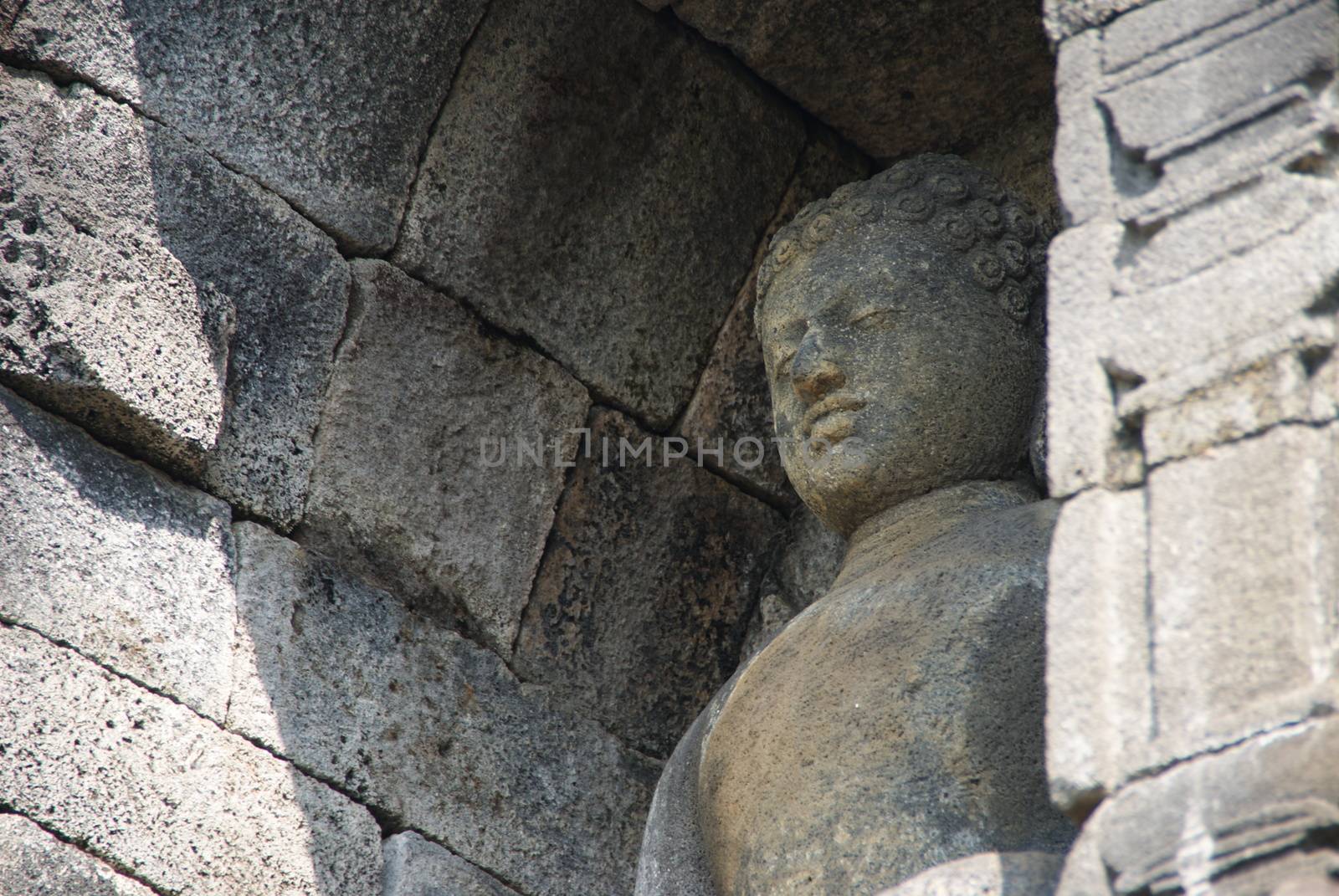 Image of sitting Buddha in Borobudur Temple, Jogjakarta, Indonesia by craigansibin