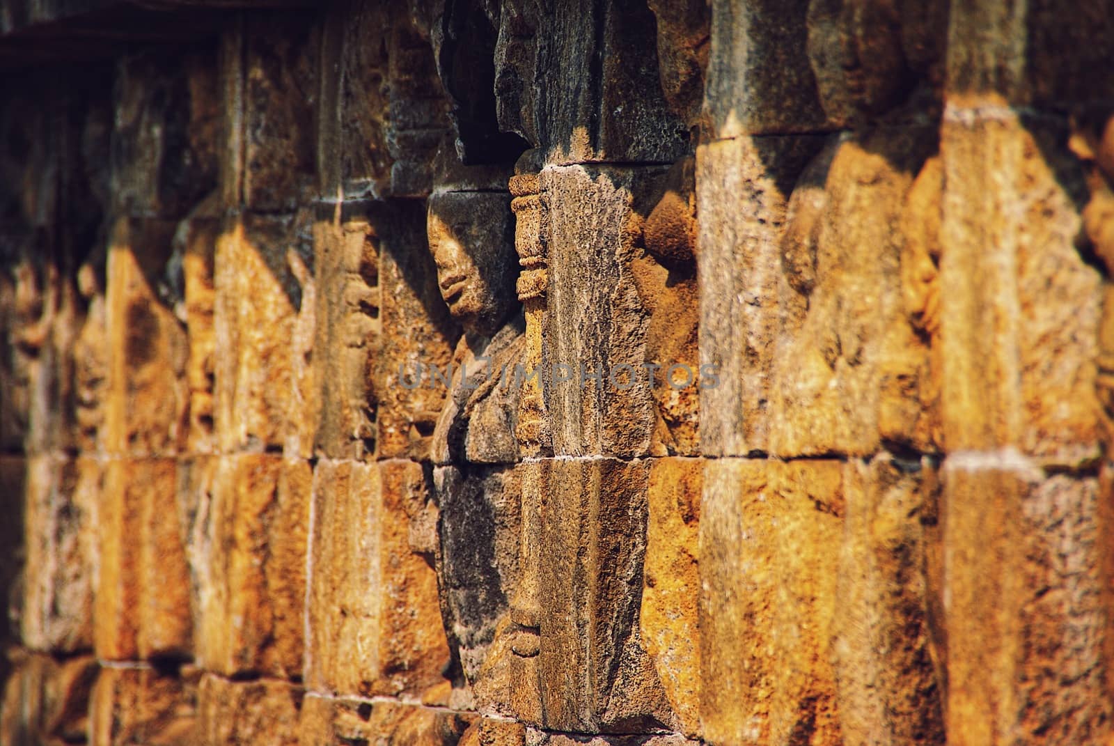 Relief or carvings on the wall of Borobudur Temple in Jogjakarta, Indonesia by craigansibin