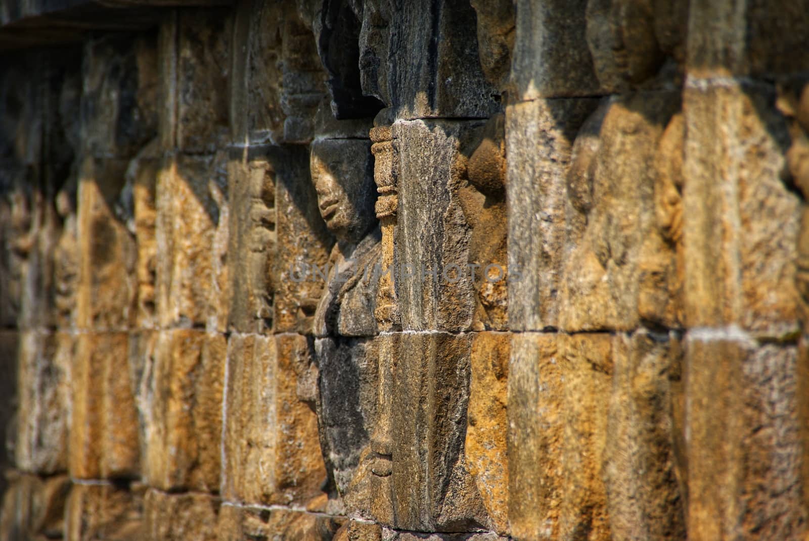 Relief or carvings on the wall of Borobudur Temple in Jogjakarta, Indonesia by craigansibin