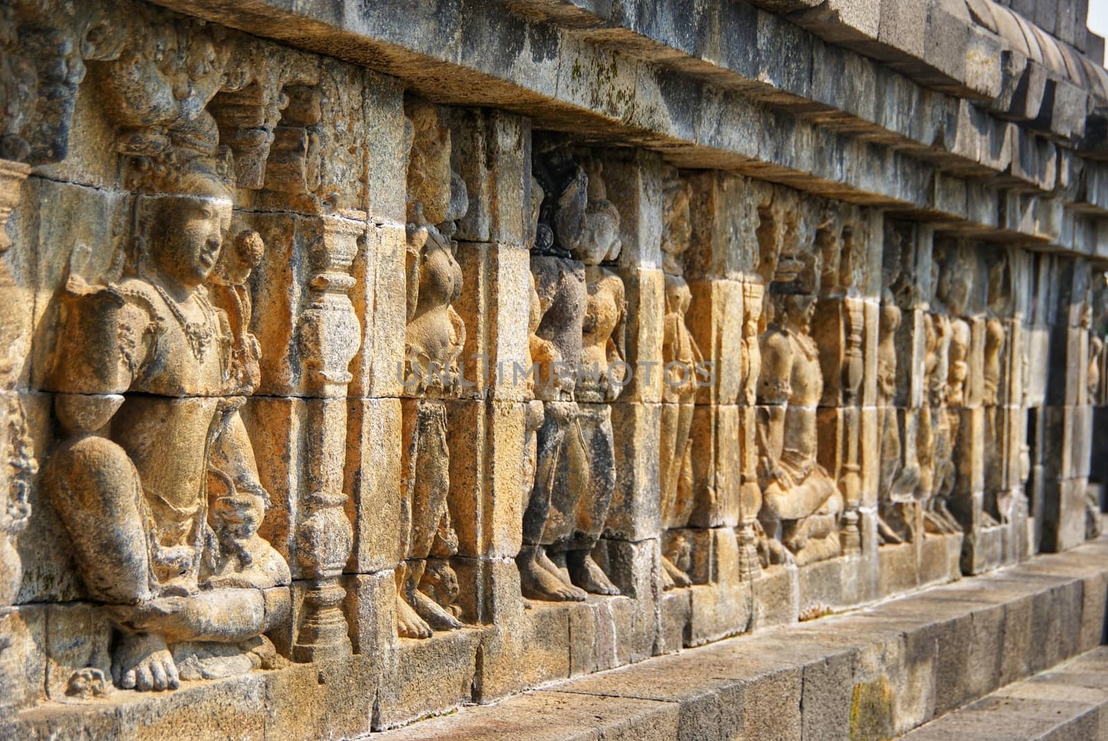 Relief or carvings on the wall of Borobudur Temple in Jogjakarta, Indonesia by craigansibin