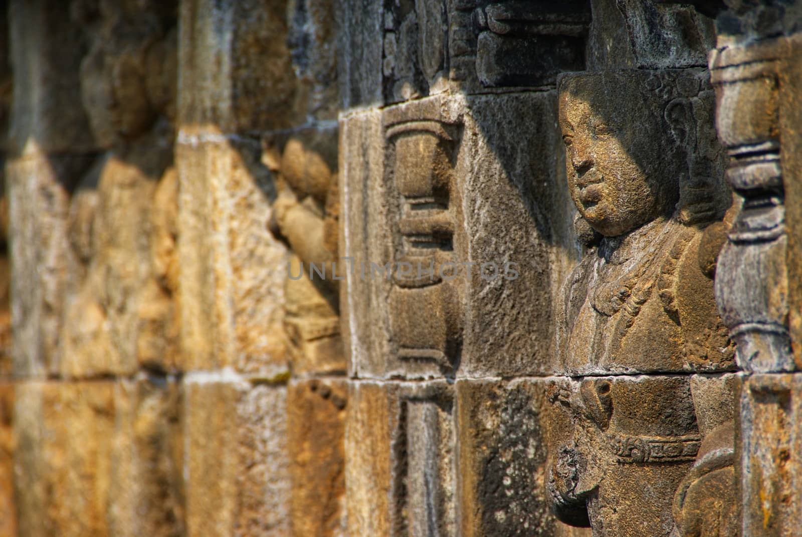 Relief or carvings on the wall of Borobudur Temple in Jogjakarta, Indonesia by craigansibin