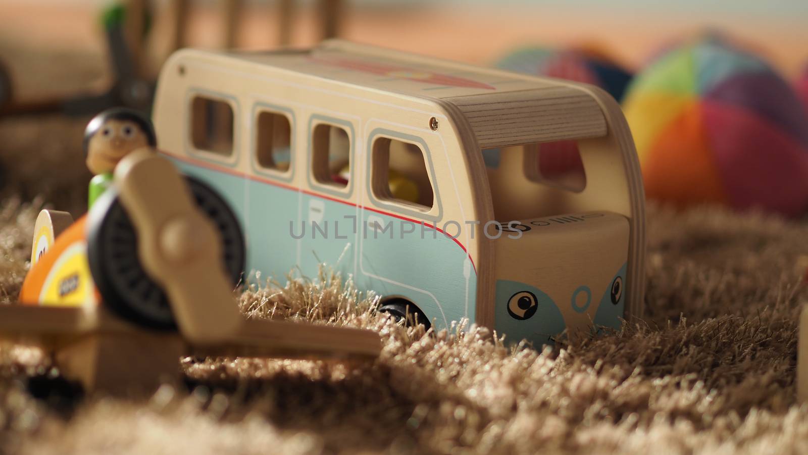 Colorful baby wood toys on light brown color carpet  by gnepphoto