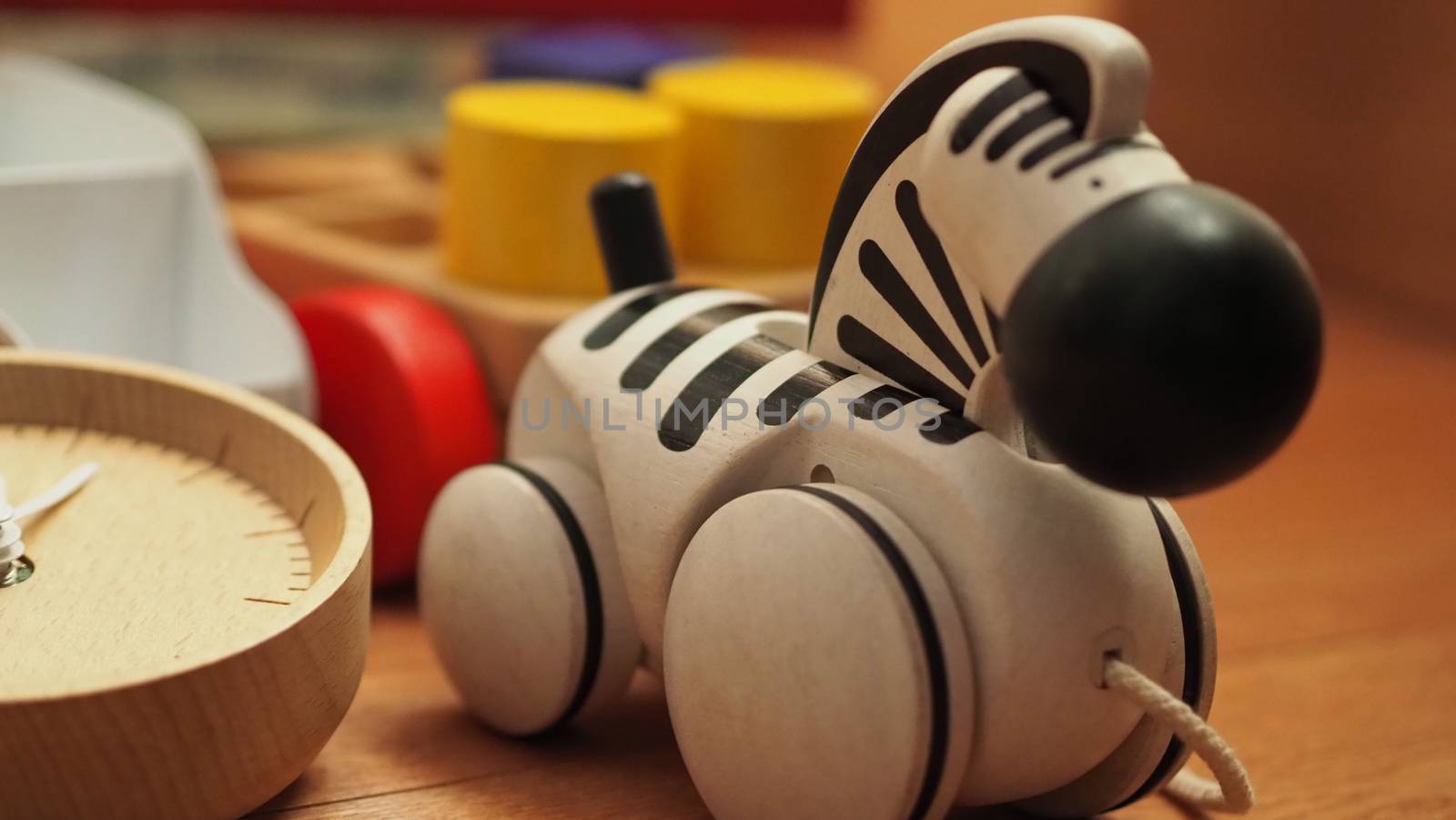 Colorful baby wood toys on light brown color carpet  by gnepphoto