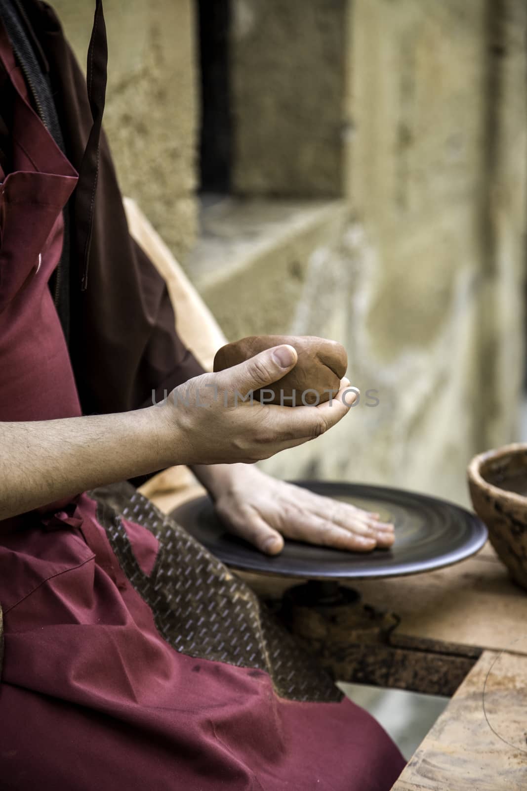 Hands of man working and shaping clay, potter in pottery, craft detail, creation