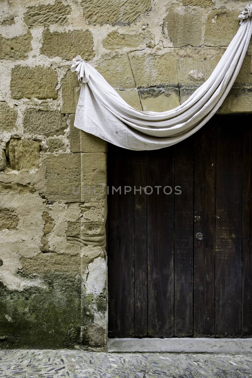 Old medieval wooden door with lock, detail of decoration and protection, antiquity