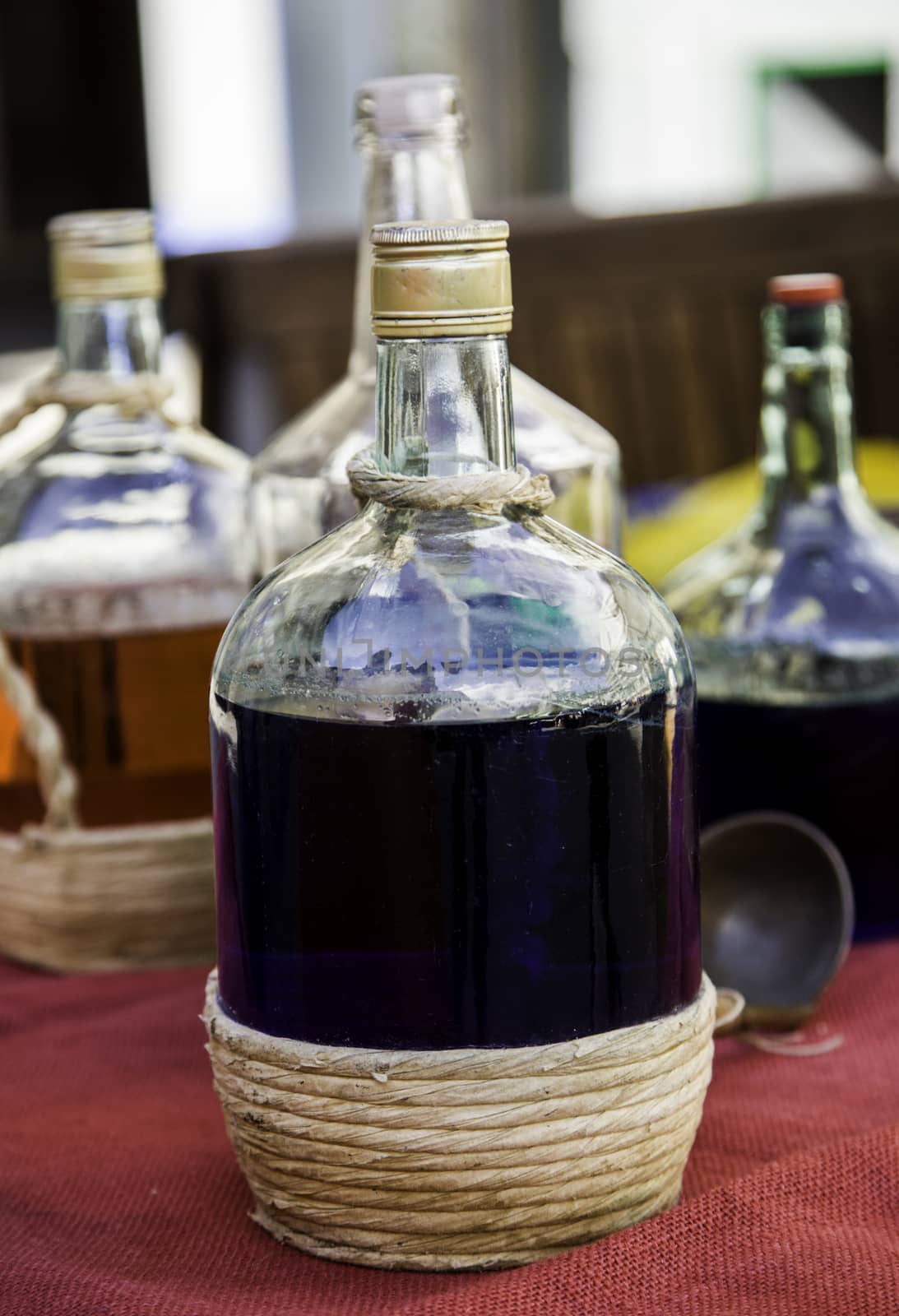 Bottles with colored liquid, detail of colors and glass, containers