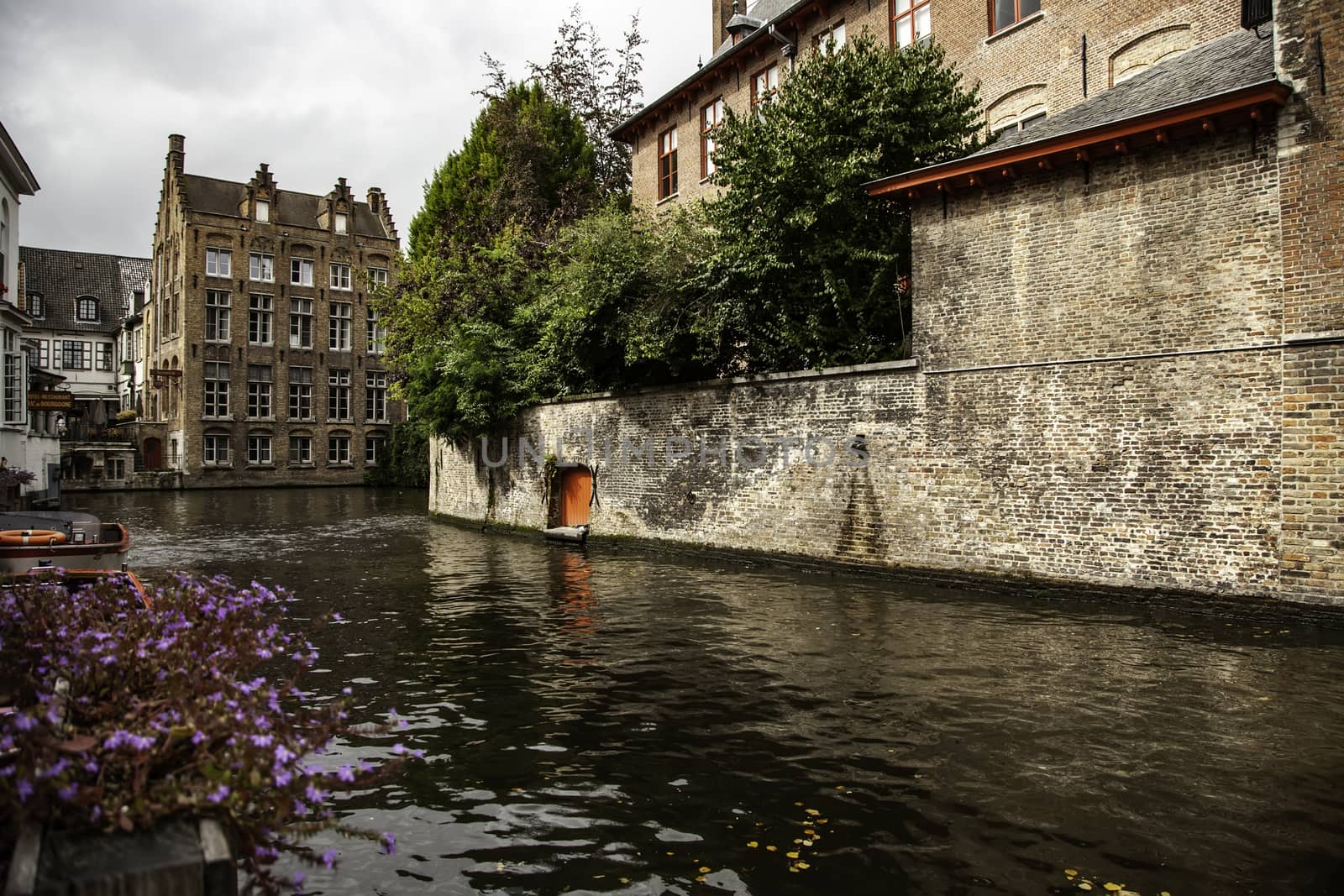 Medieval channels of Bruges, detail of tourism in a city of Belgium