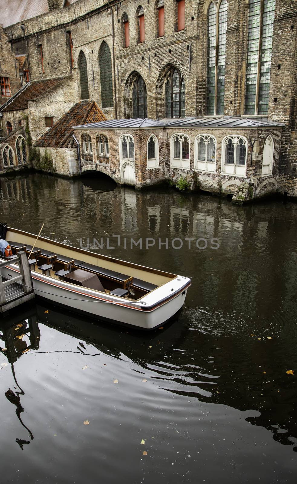 Medieval channels of Bruges, detail of tourism in a city of Belgium