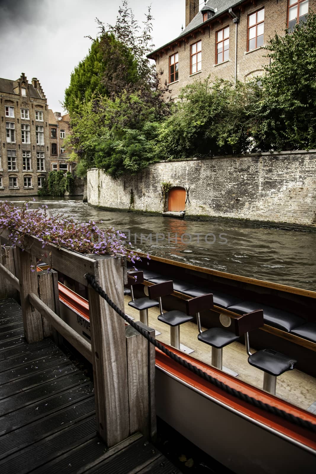 Medieval channels of Bruges, detail of tourism in a city of Belgium