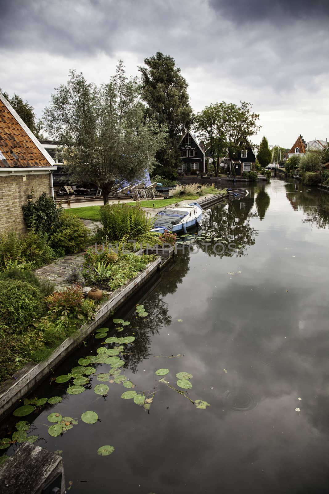 Medieval channels of Bruges, detail of tourism in a city of Belgium