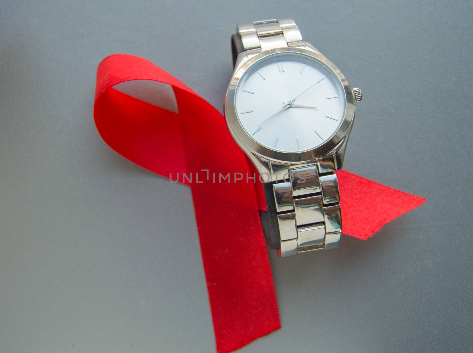 World AIDS day, the symbol of the red ribbon and the clock - do not waste time to start treatment.