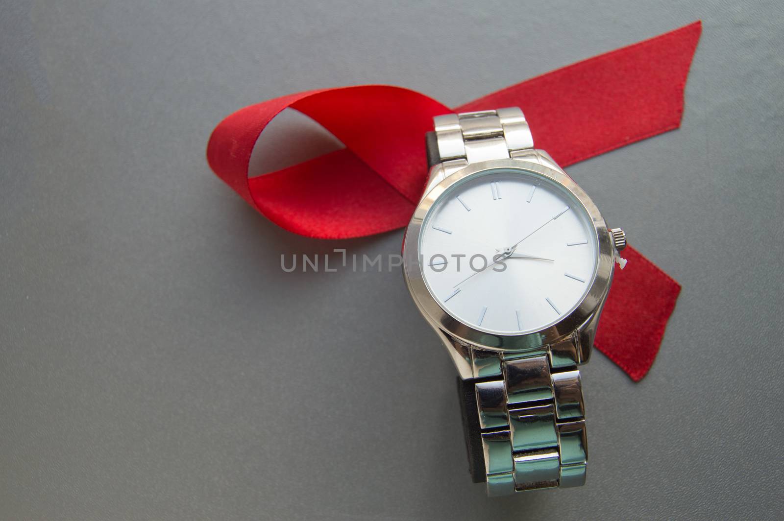 World AIDS day, the symbol of the red ribbon and the clock - do not waste time to start treatment by claire_lucia