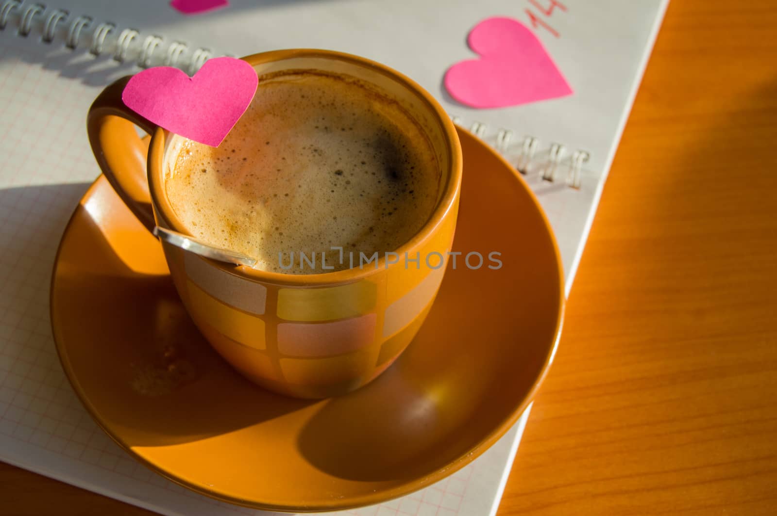 Preparation for Valentine's Day: the notebook and hearts, Cup of coffee, close-up.