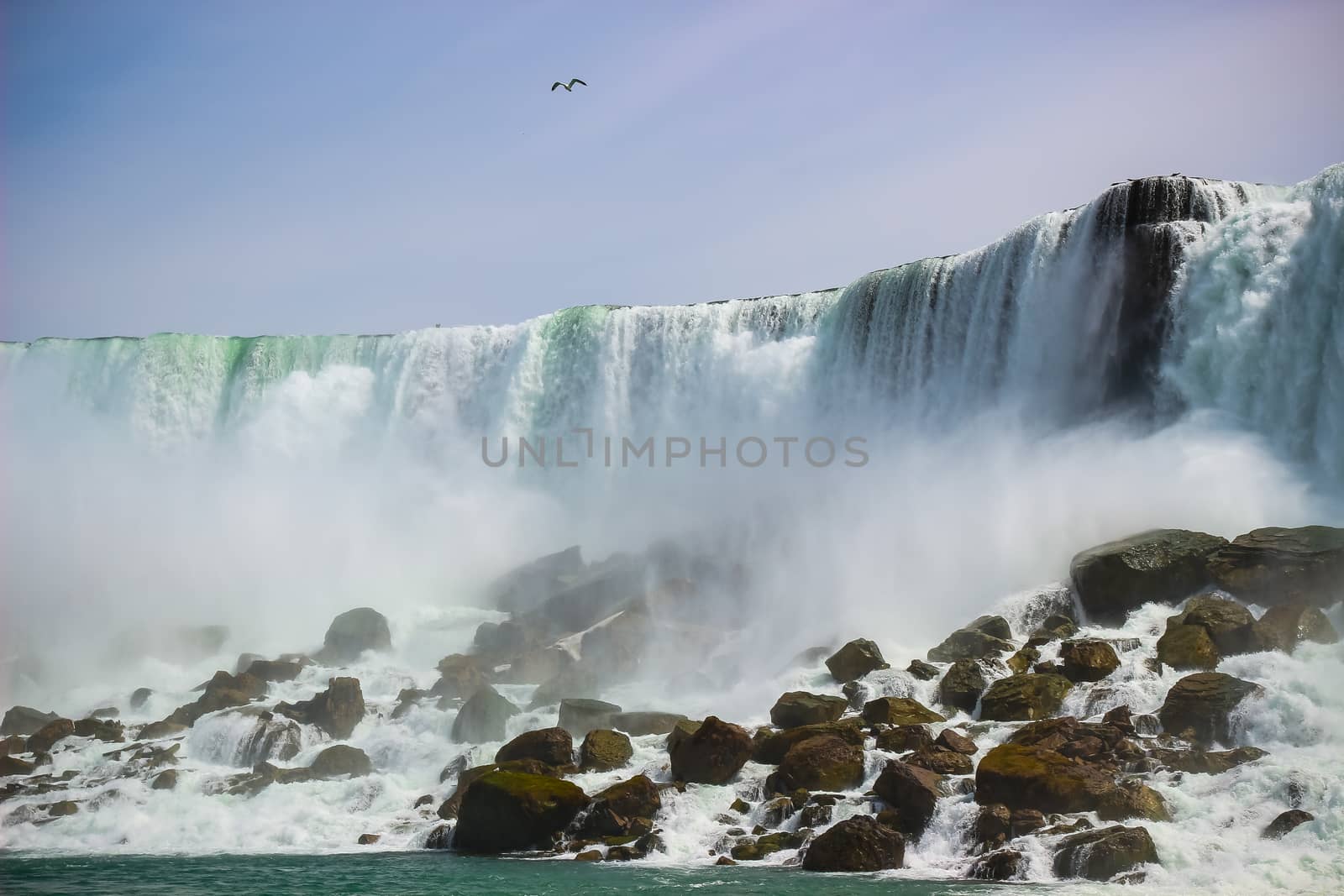 American side of the beautiful Niagara falls, New York, USA. View from the boat in the river.