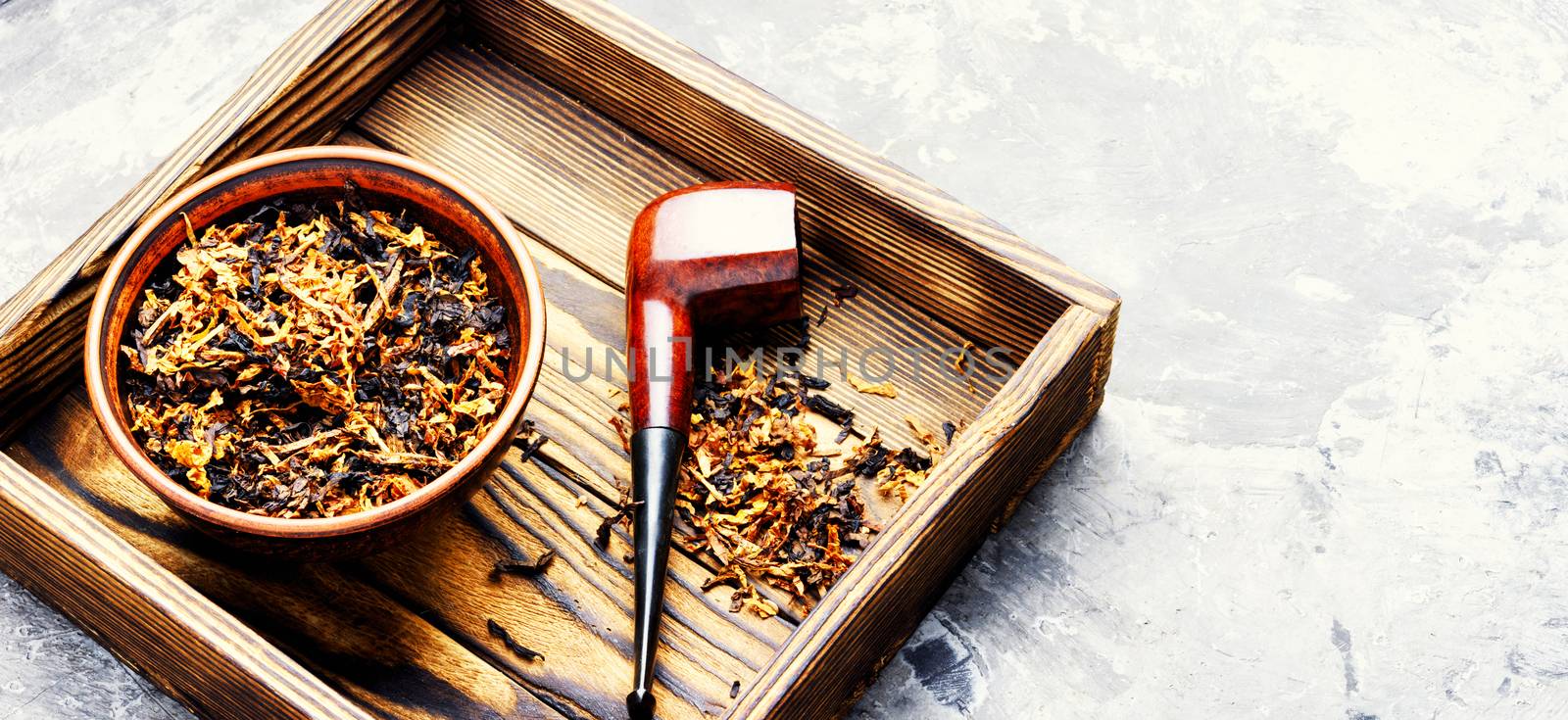 Classic tobacco smoking pipe with dried tobacco.Smoking.