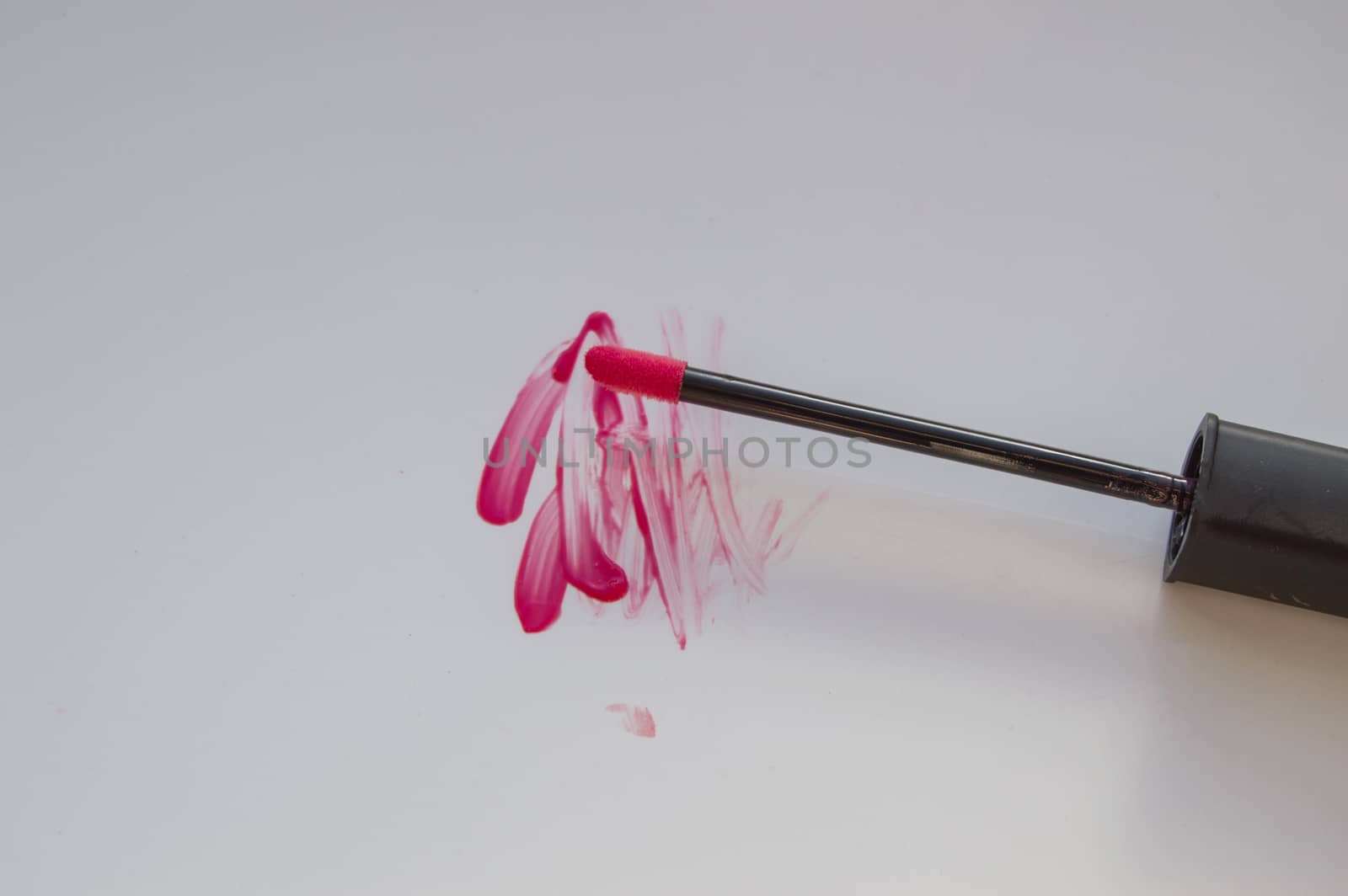 beautiful pink lip gloss smear with brush, isolated on white background by claire_lucia